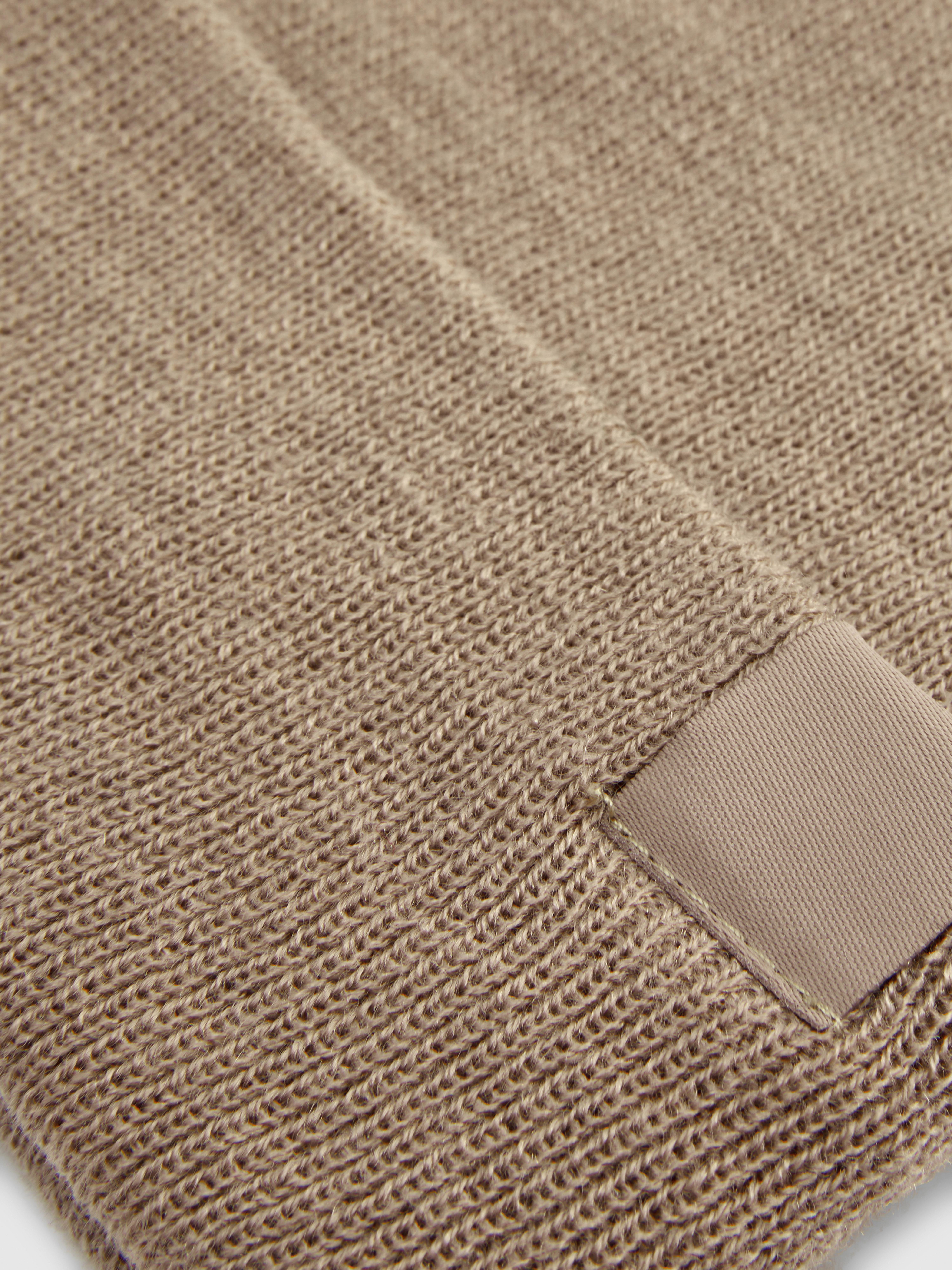 Berretto a maglia fine con collo a coste. Questo berretto lavorato a maglia con una trama a coste sottili è perfetto per le giornate fredde.