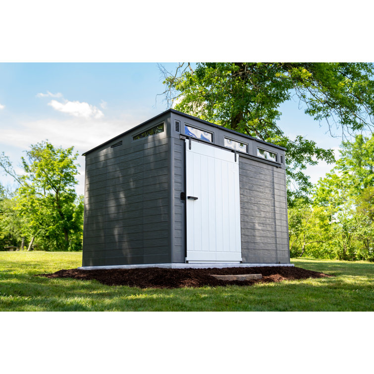 Casinha de armazenamento Suncast Modernist com porta de celeiro, 3,29 m de largura x 2,22 m de profundidade, em resina.