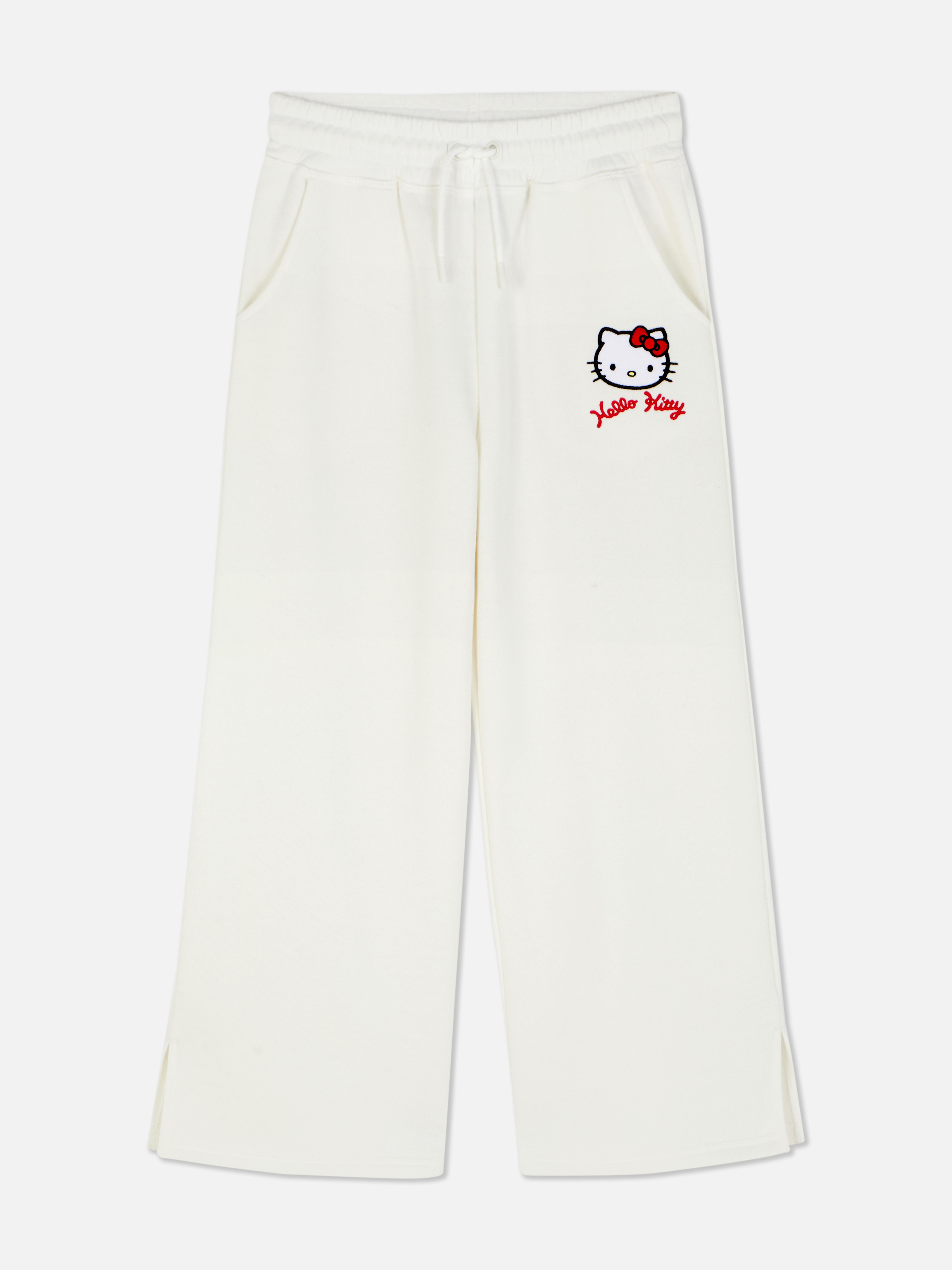 Pantaloni de trening cu croi larg, cu imprimeu Hello Kitty and Friends. Pantaloni de trening cu șnur de strângere, buzunare laterale, tiv despicat și design Sanrio.