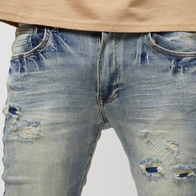 Vintage gewassen jeans met scheuren en reparaties