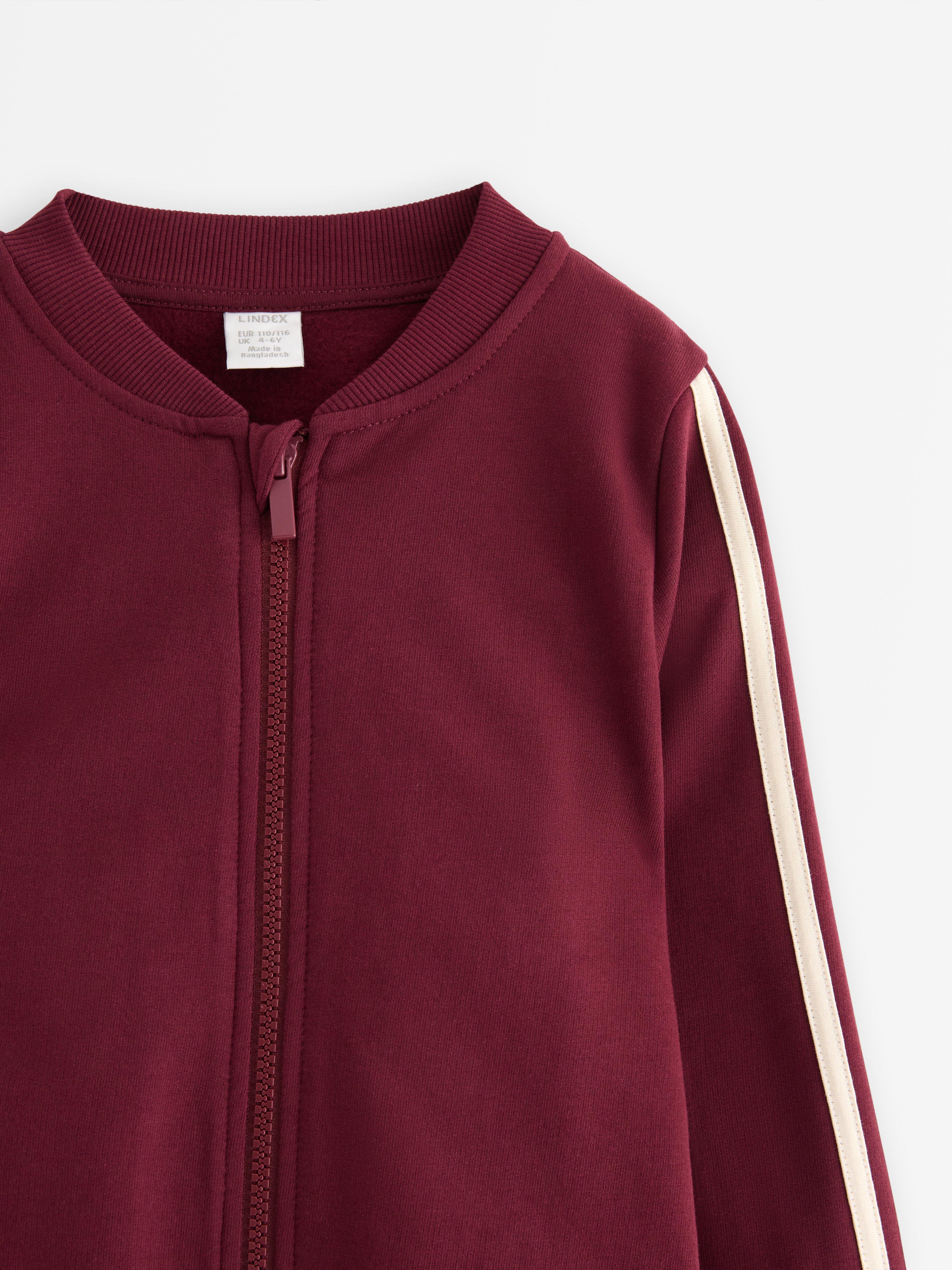 Sudadera con cremallera, color rojo oscuro empolvado.