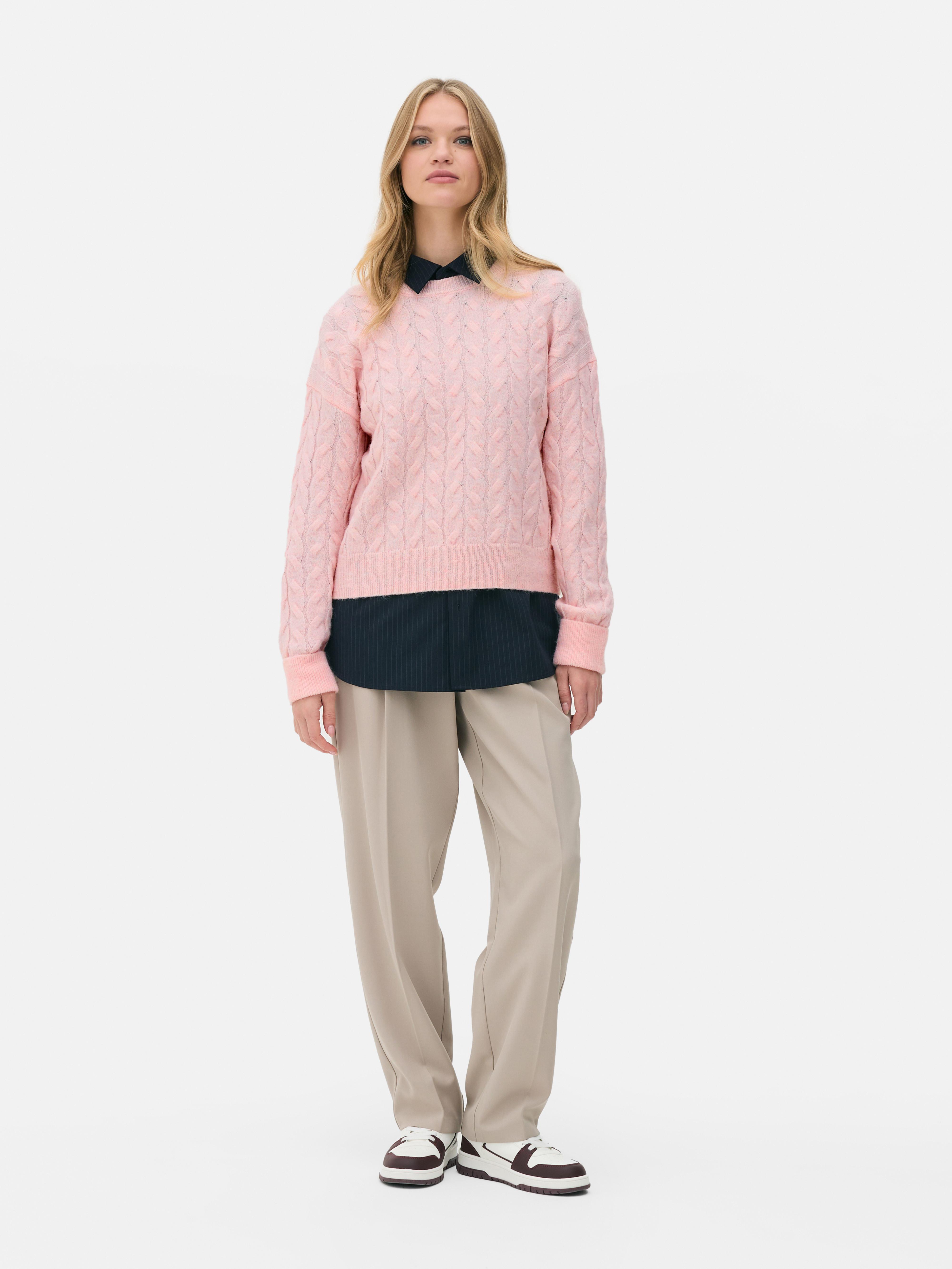 Cable sweater A cable-knit sweater with a round neck and classic fit