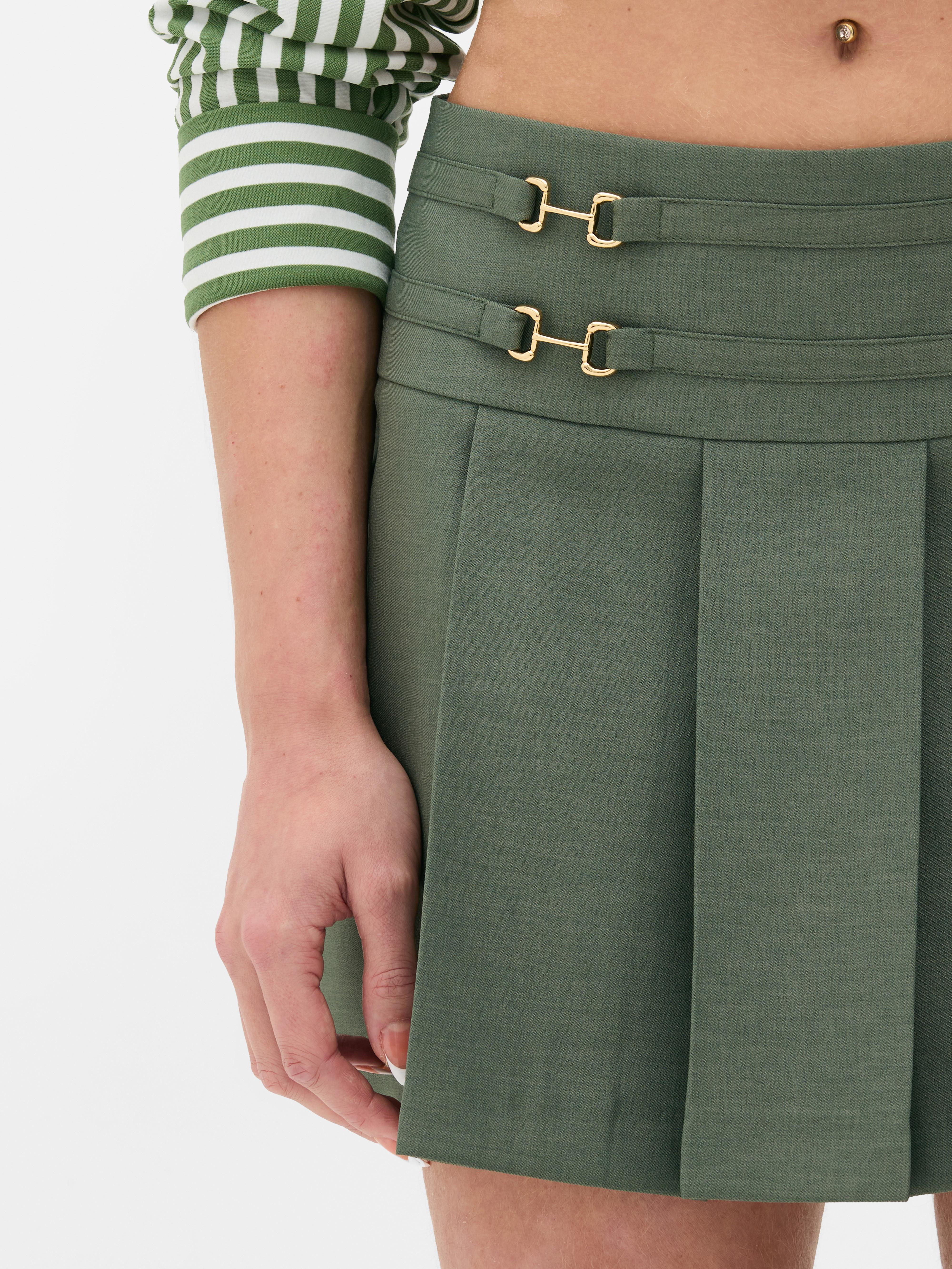 Pleated mini skirt A pleated mini skirt with metallic bit details