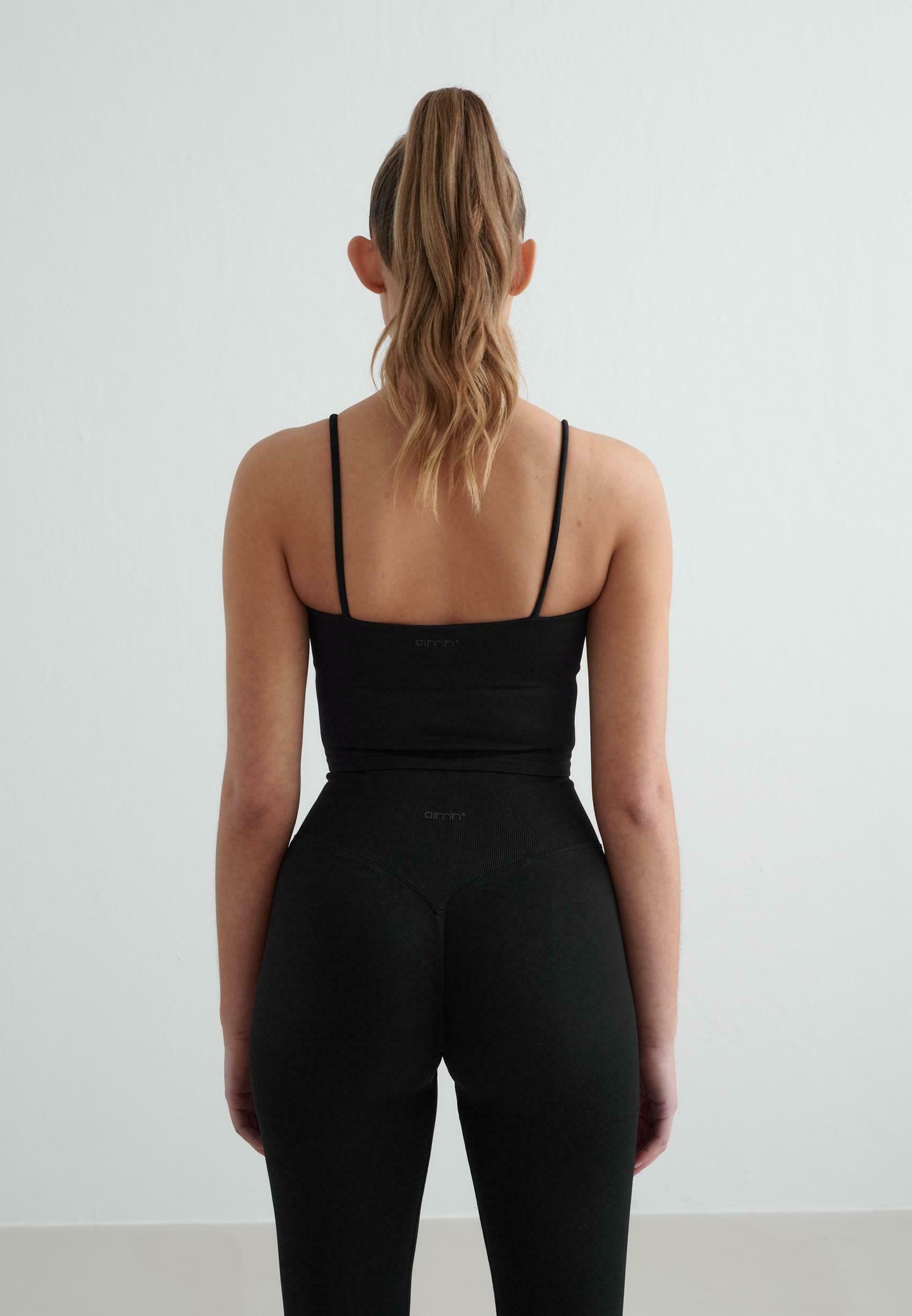 aim'n® SHAPE SEAMLESS SINGLET - Sutiã esportivo de suporte leve - preto