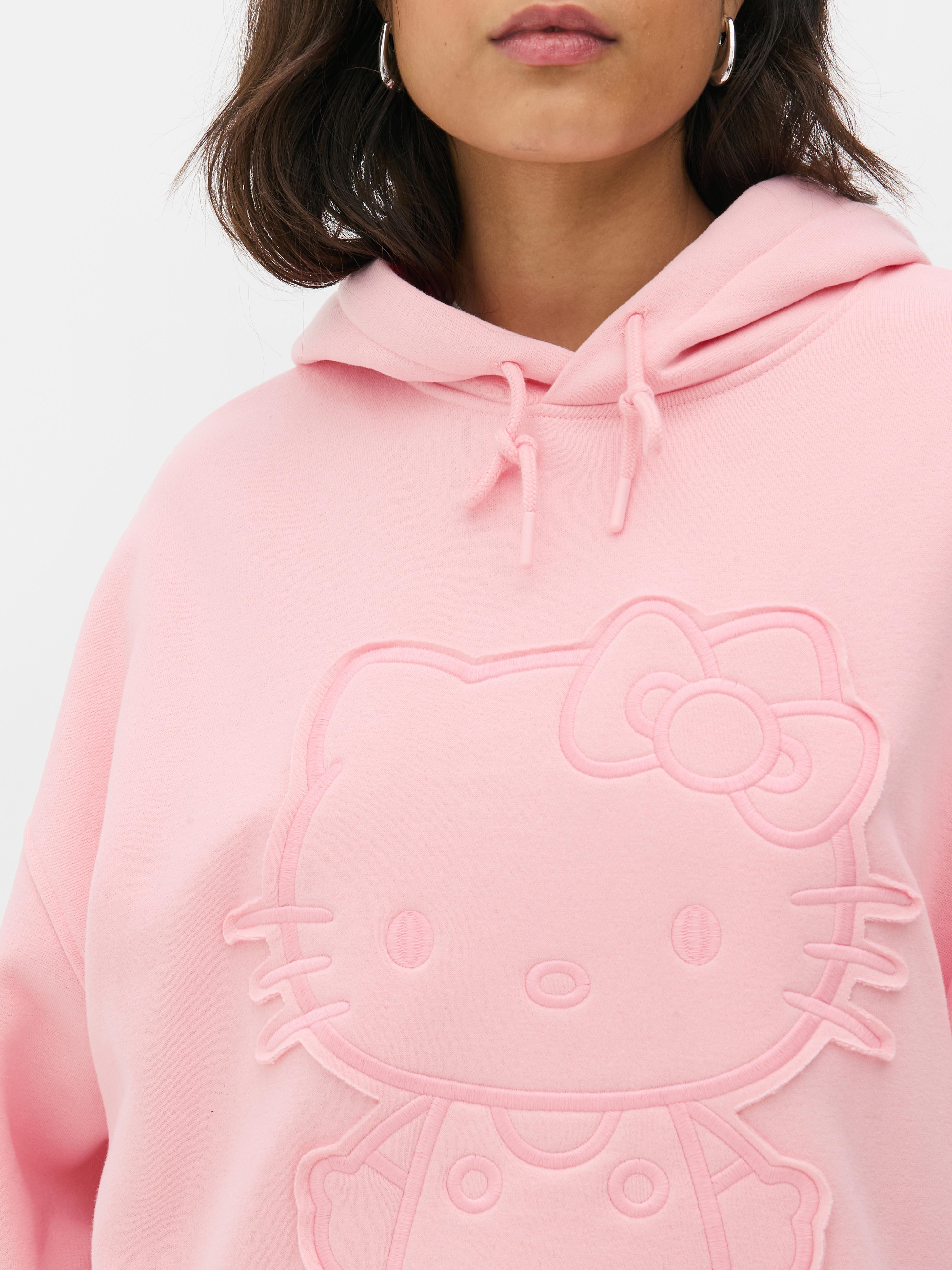 Hanorac supradimensionat cu broderie Hello Kitty. Acest hanorac cu Hello Kitty este un plus distractiv pentru ținuta ta casual.