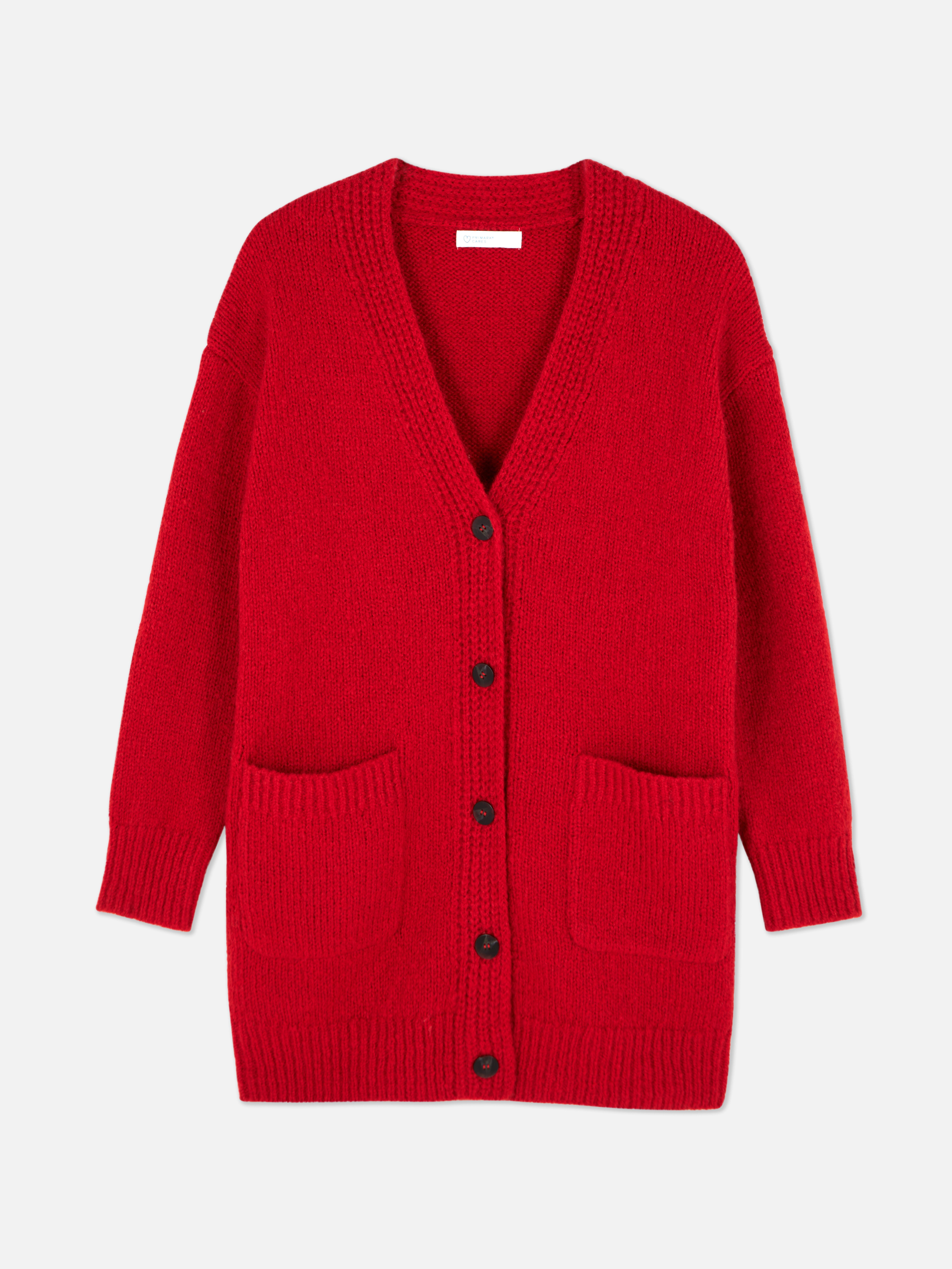 Oversize-Strickjacke. Eine lange Strickjacke mit Oversize-Schnitt, V-Ausschnitt und aufgesetzten Taschen.