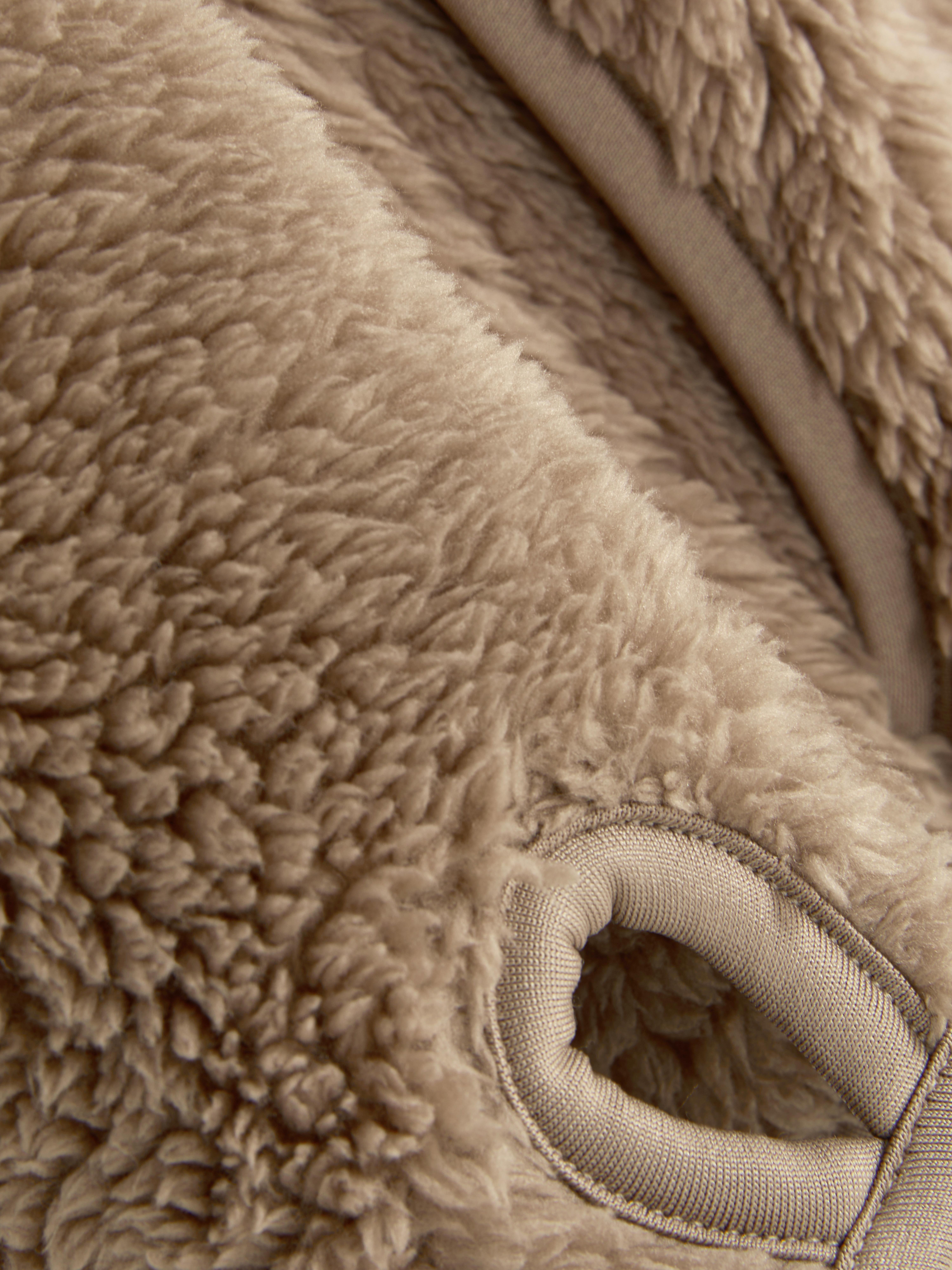 Teddy fleece zippered jacket. A soft teddy fleece jacket with long sleeves, a stand-up collar, and a full-length zipper.