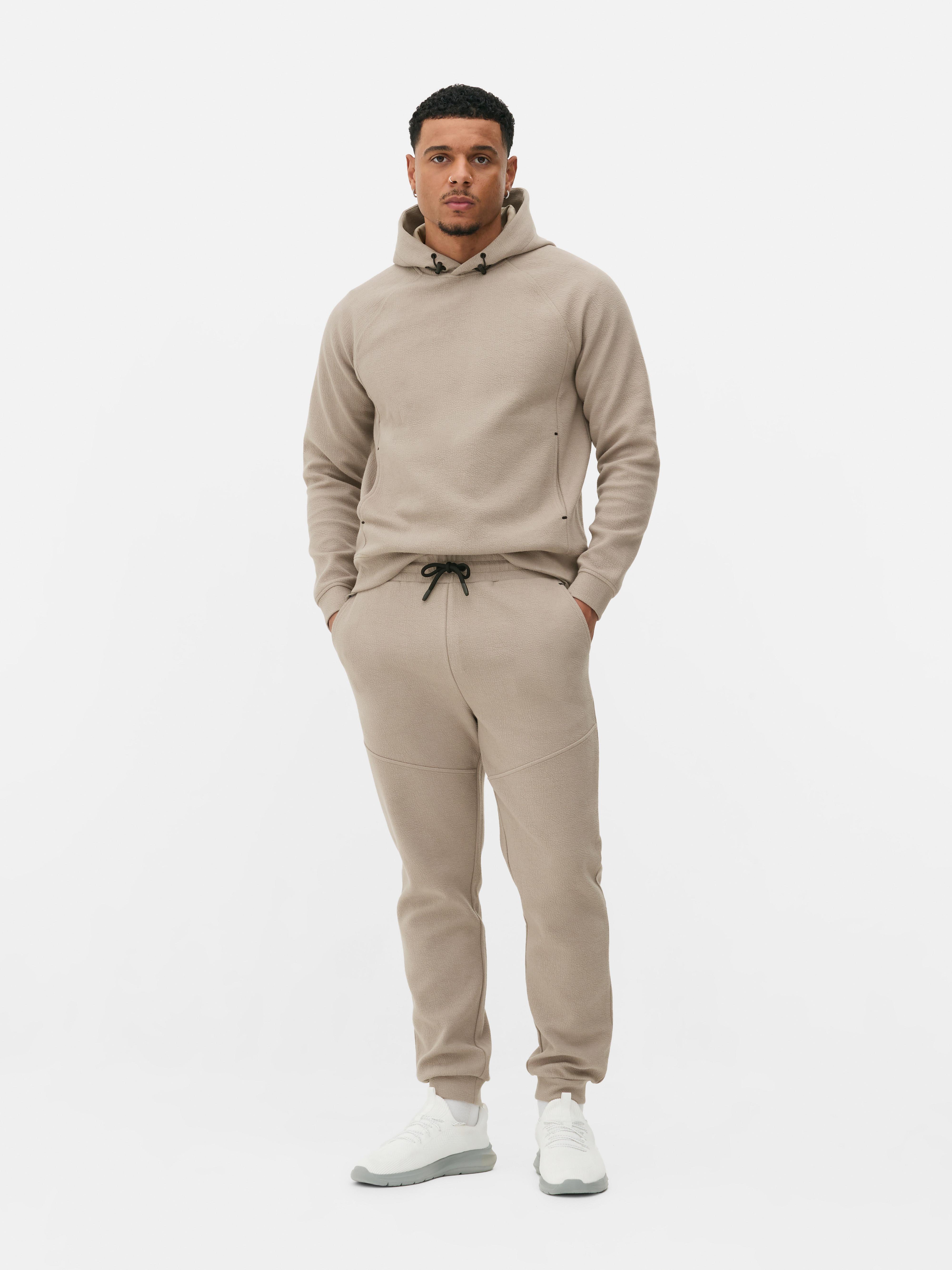 Pantaloni de trening texturați cu șnur de strângere Pantaloni de trening cu șnur de strângere, buzunare laterale, clinuri și manșete la gleznă