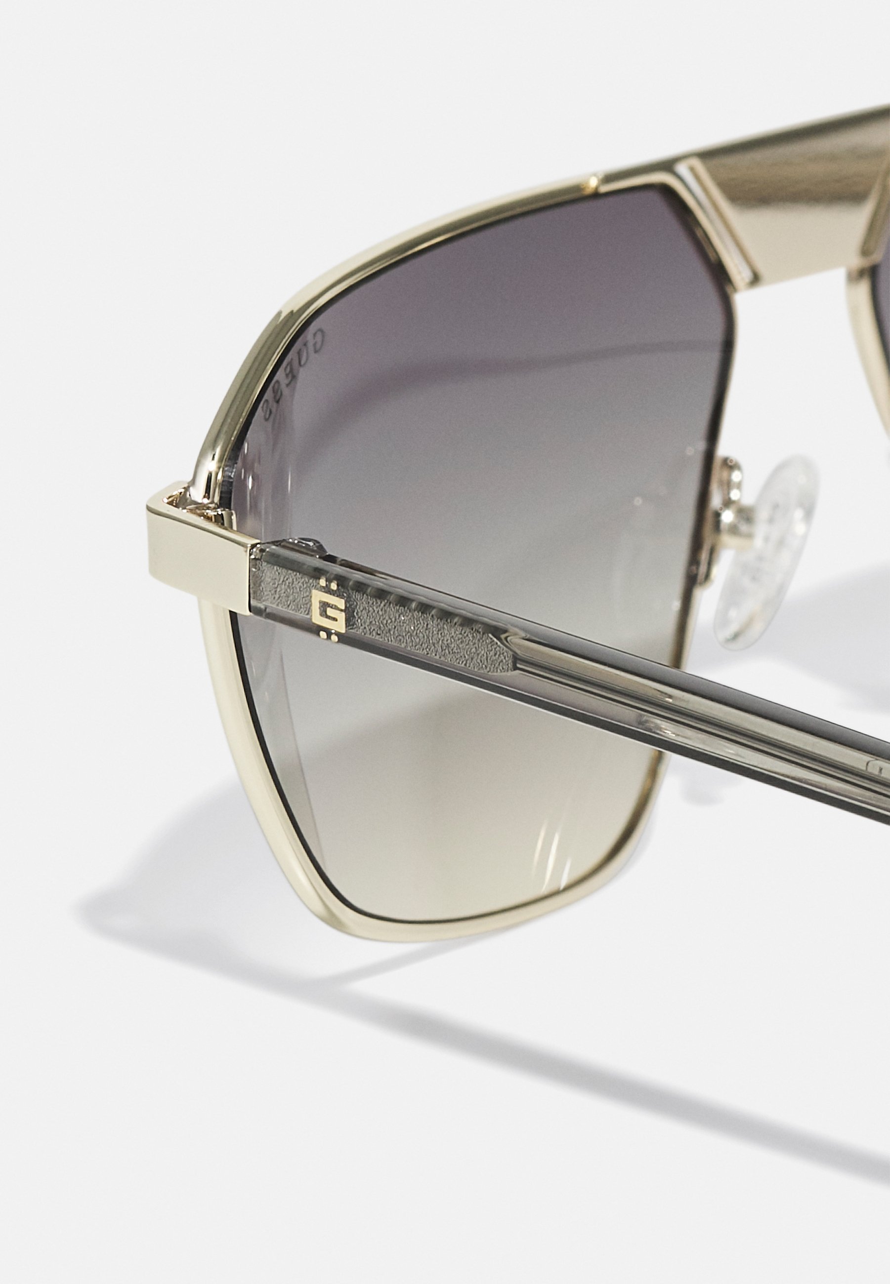 Guess UNISEX - Zonnebril - goudkleurig