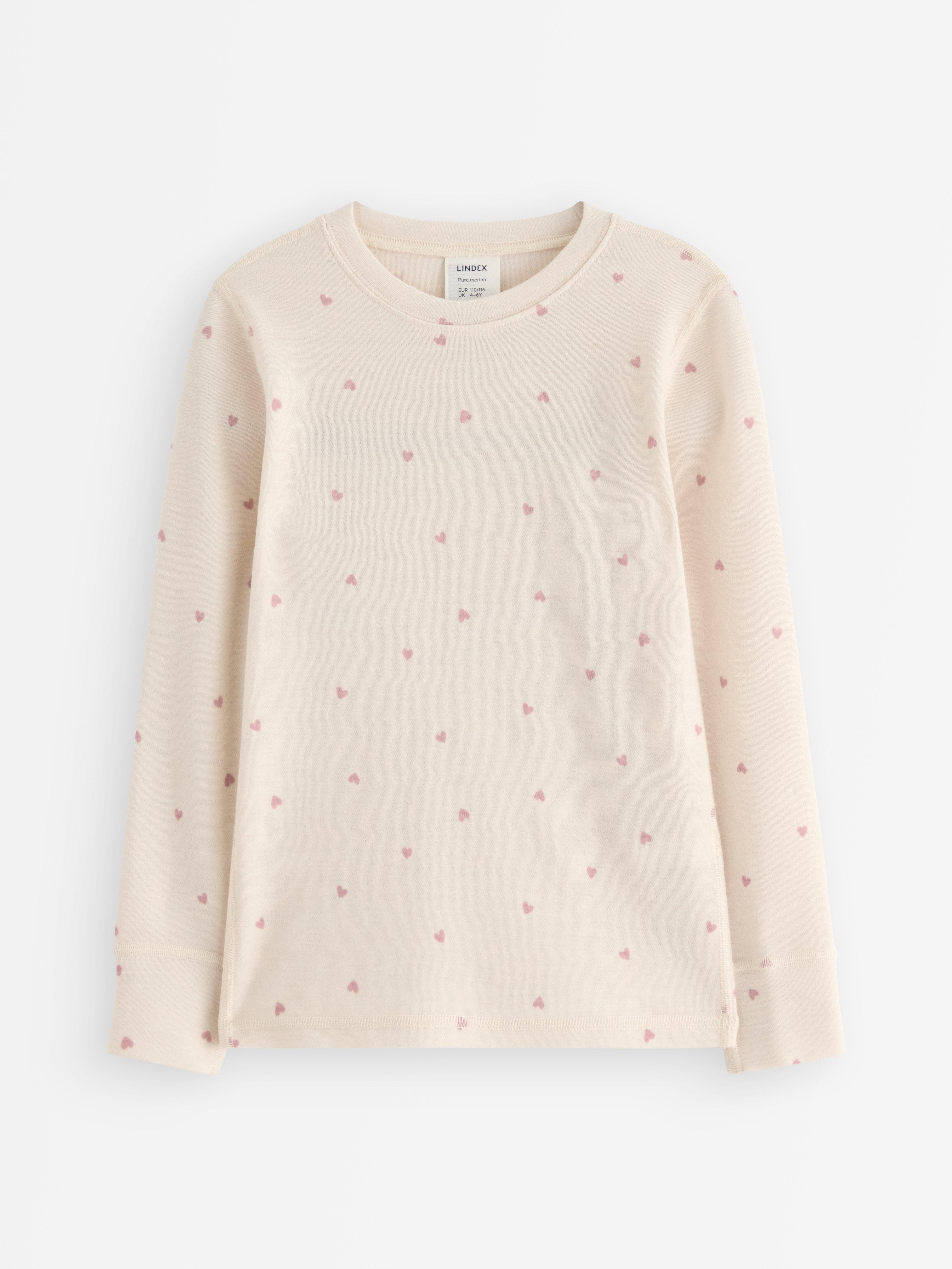 Top de manga larga de lana merino color beige claro.