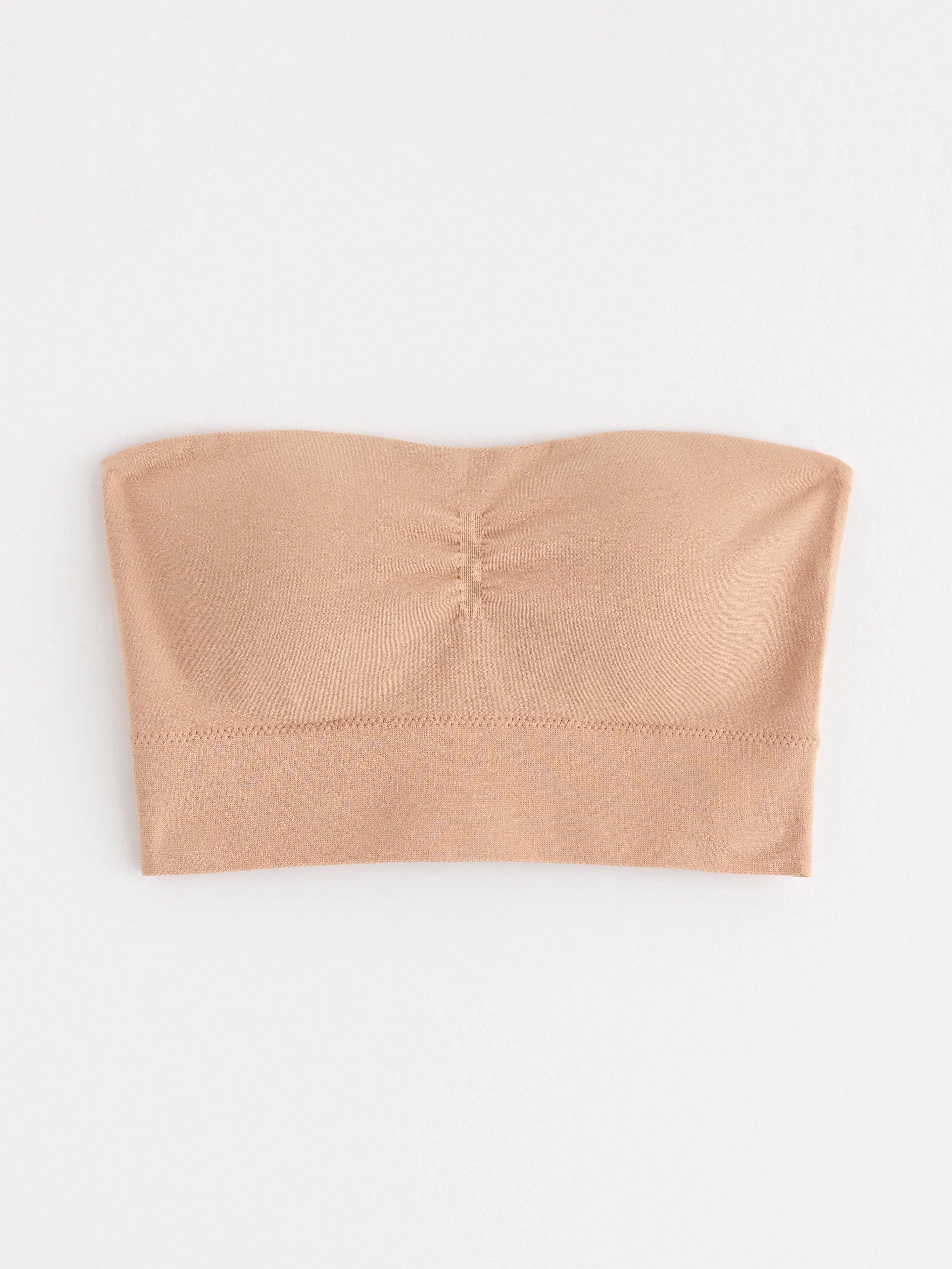 Sujetador bandeau sin costuras, color beige.