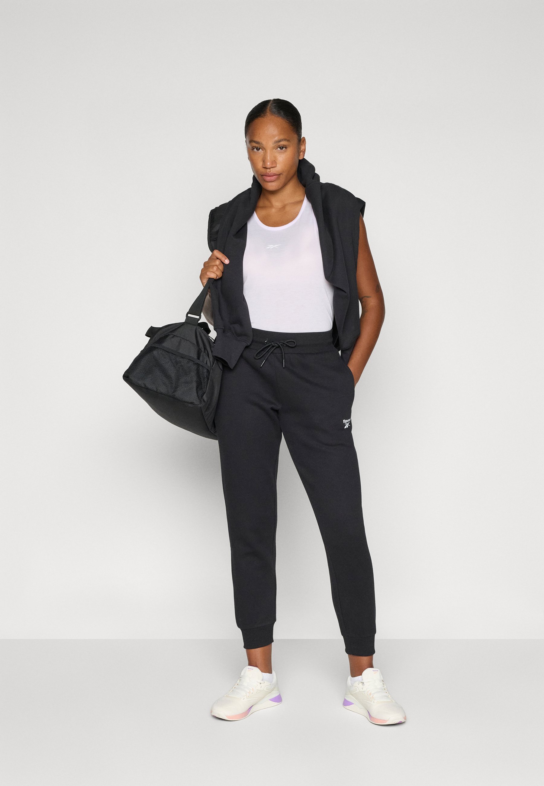 Pantaloni da tuta Reebok con piccolo logo e risvolto - neri