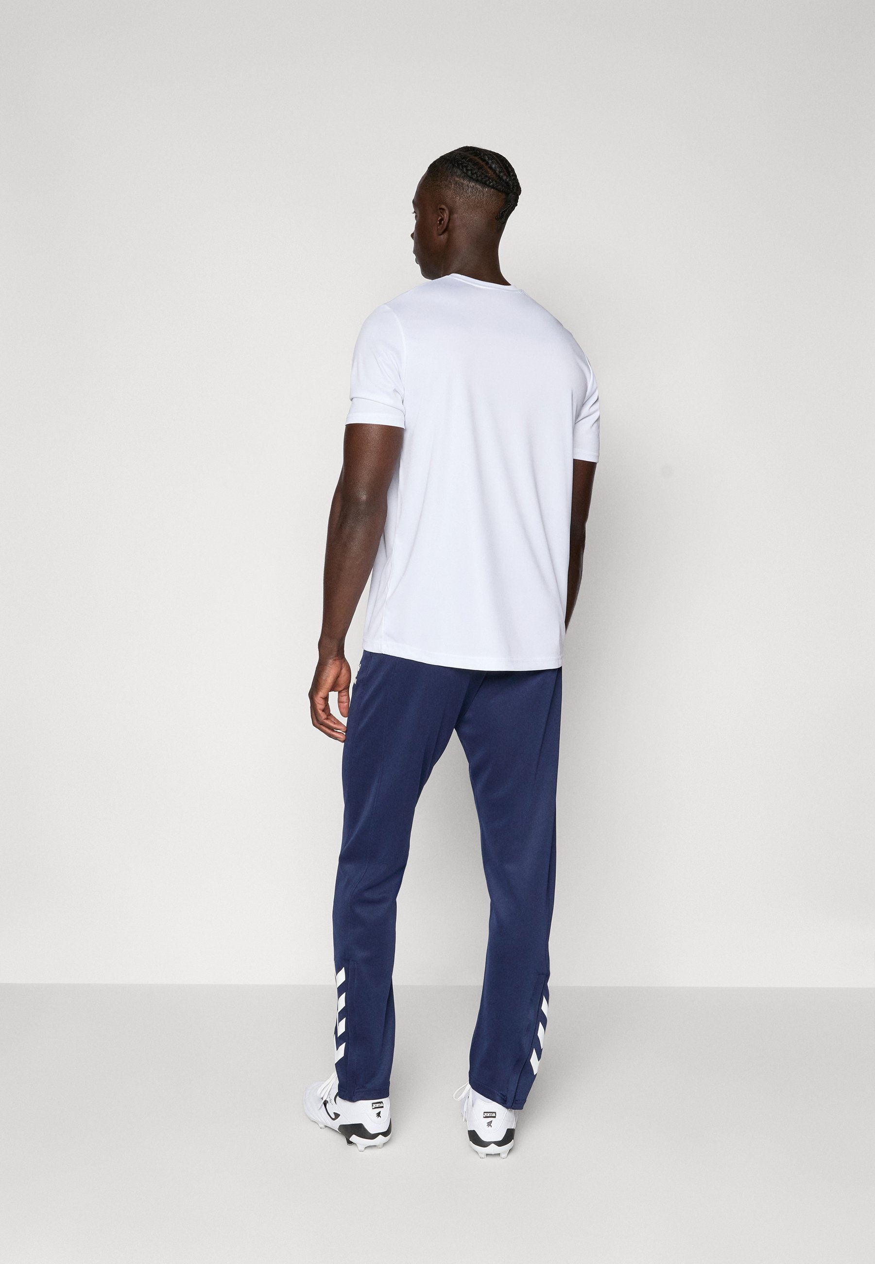 Pantaloni Hummel HMLCORE - Pantaloni da tuta - colore blu navy