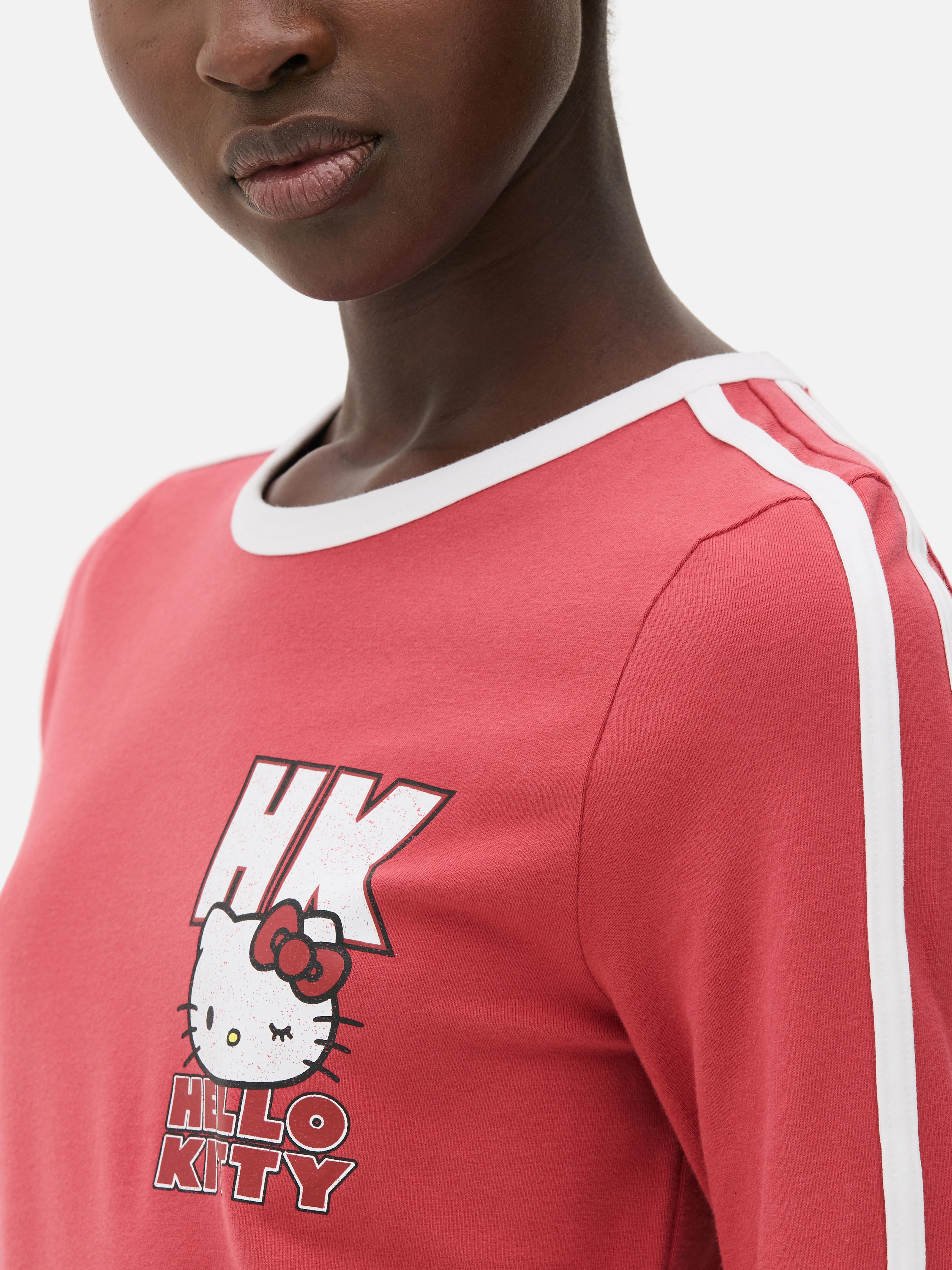 Tricou cu mânecă lungă Hello Kitty Un tricou cu guler rotund, mâneci lungi, dungi sport și logo Hello Kitty