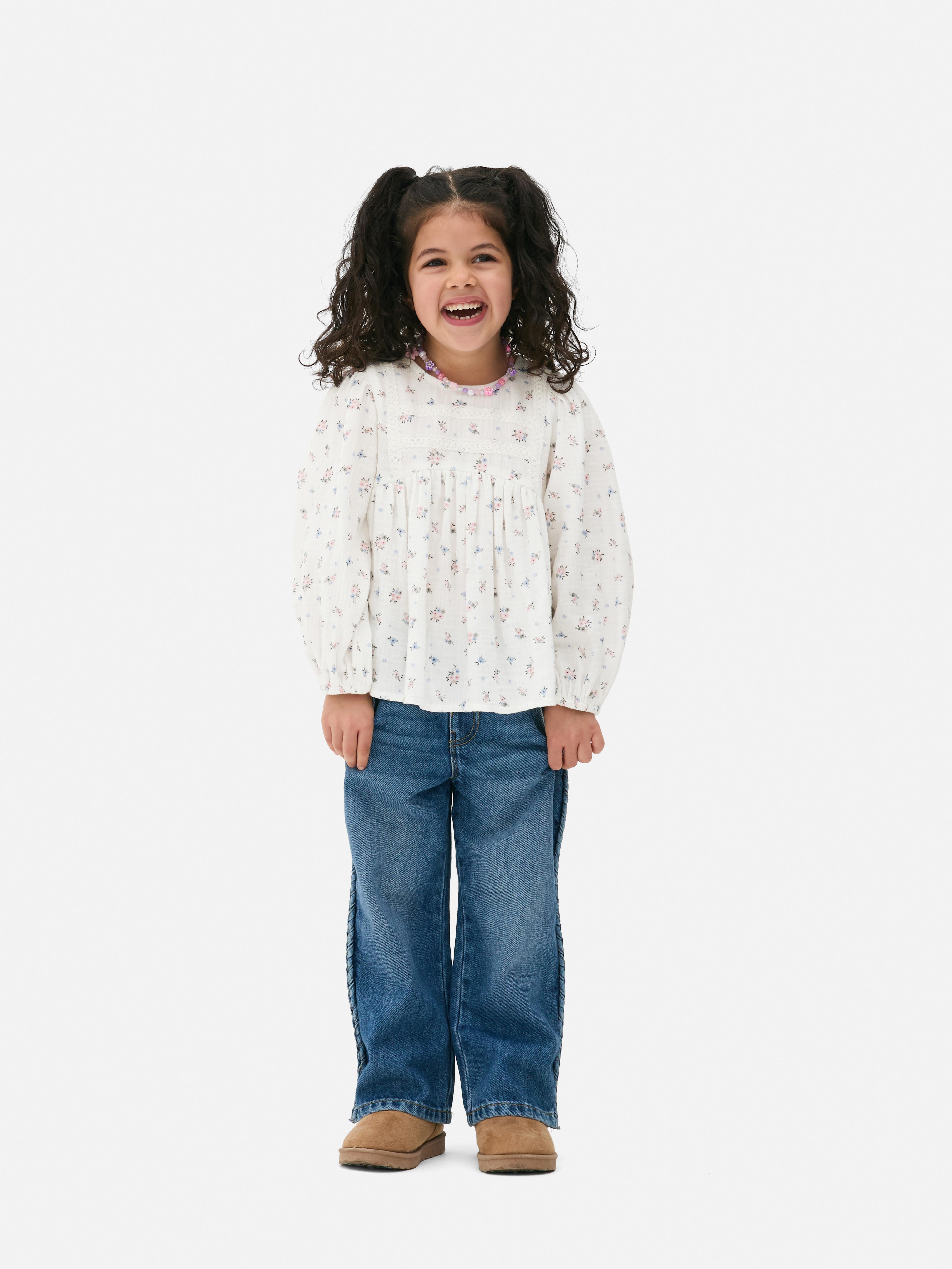 Langärmlige Bluse mit Blumenmuster Eine langärmlige Bluse mit Blumenmuster und Knopfverschluss am Rücken
