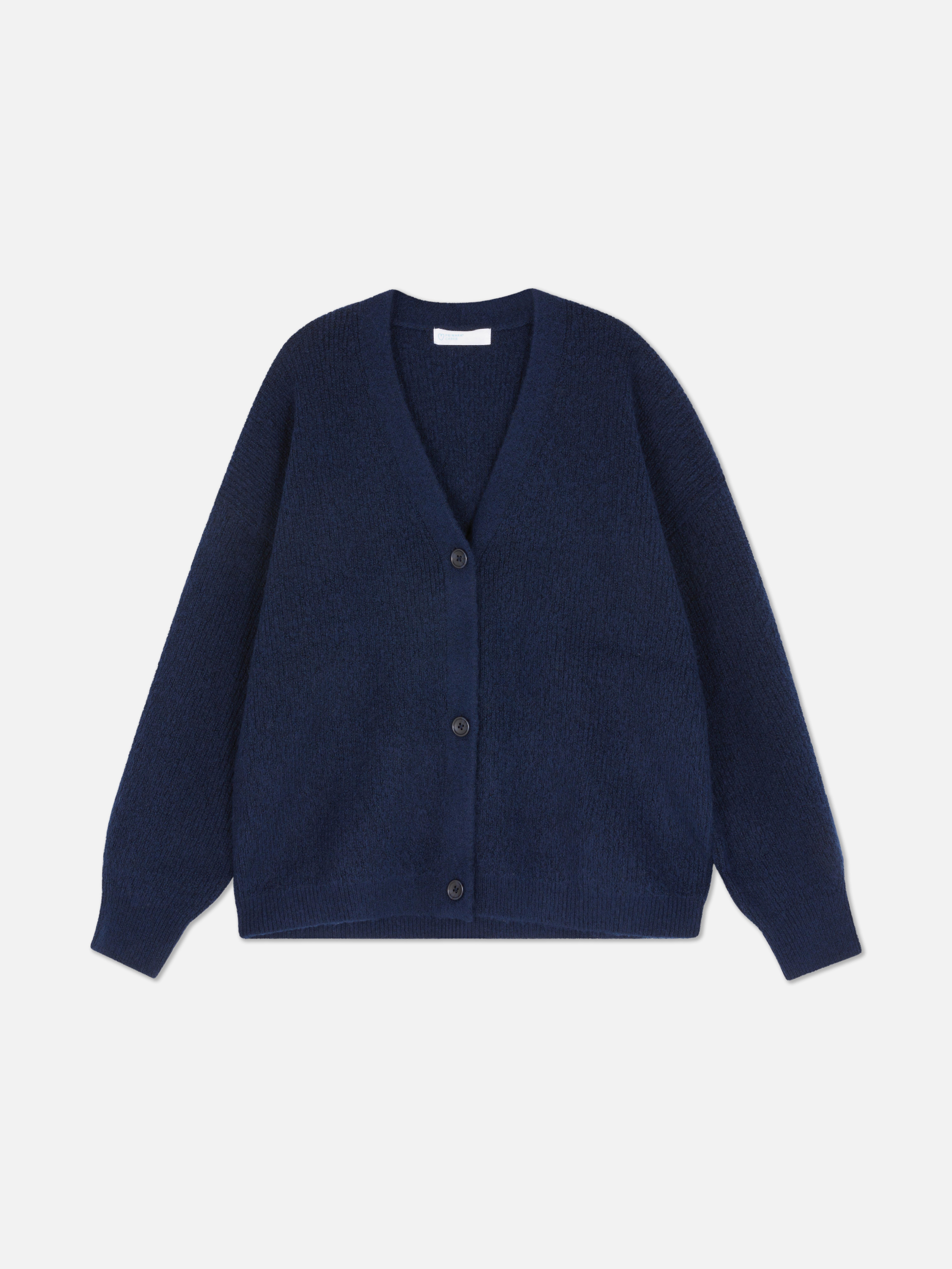 Cardigan cu decolteu în V și croială lejeră. Acest cardigan cu nasturi, croială lejeră și umeri căzuți este un clasic elegant.