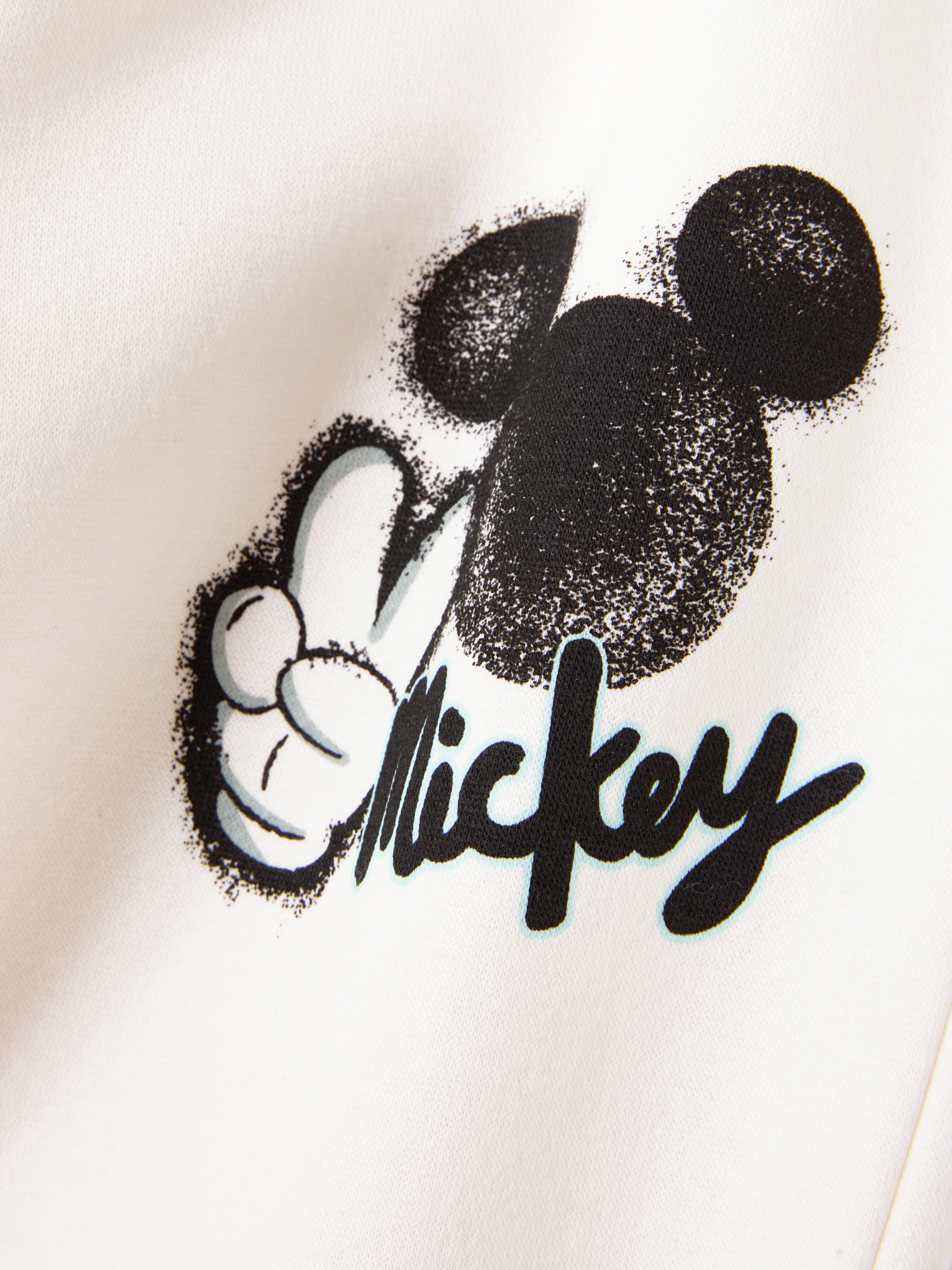 Pantaloni de trening cu șnur în talie cu model Disney Mickey Mouse. Pantaloni de trening cu șnur în talie, buzunare, manșete la gleznă și model Mickey Mouse.