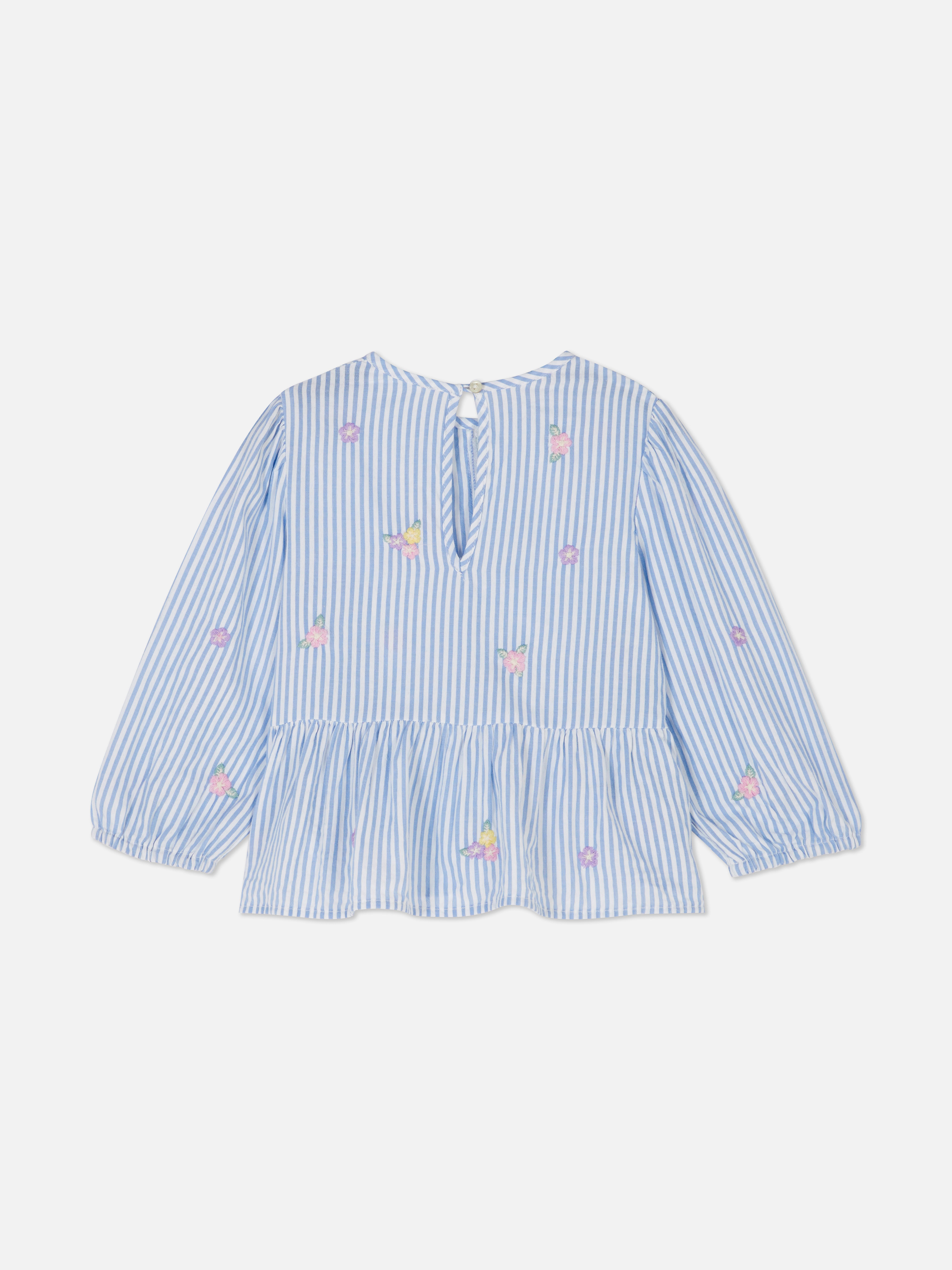 Bluse mit Blumenmuster und Schleife. Eine Bluse mit Schleife, langen Ärmeln, Blumenstickerei und einem Schlüssellochverschluss am Rücken.
