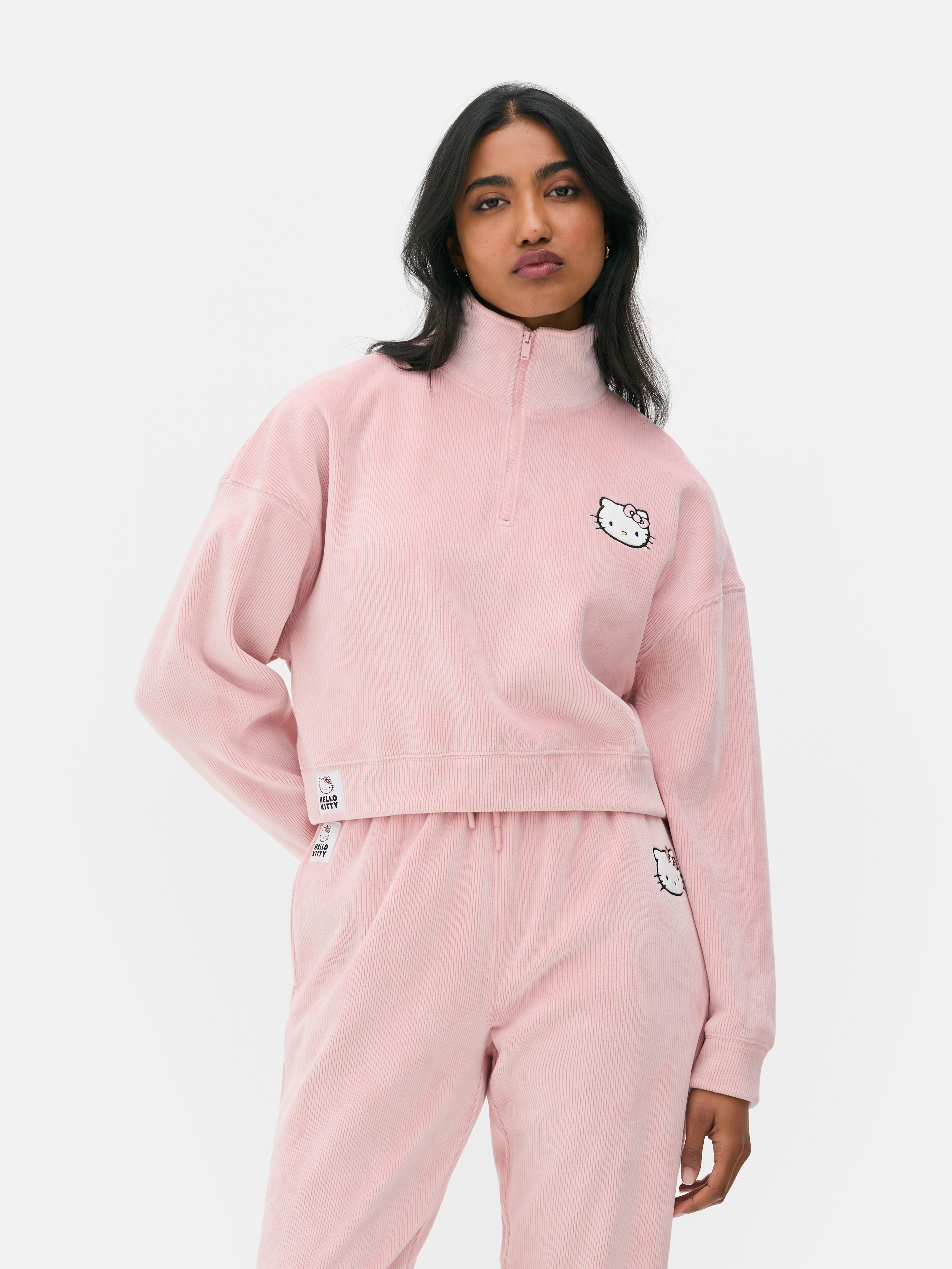 Velúr Hello Kitty pulóver Egy velúr Hello Kitty pulóver negyedcipzárral és hosszú ujjakkal