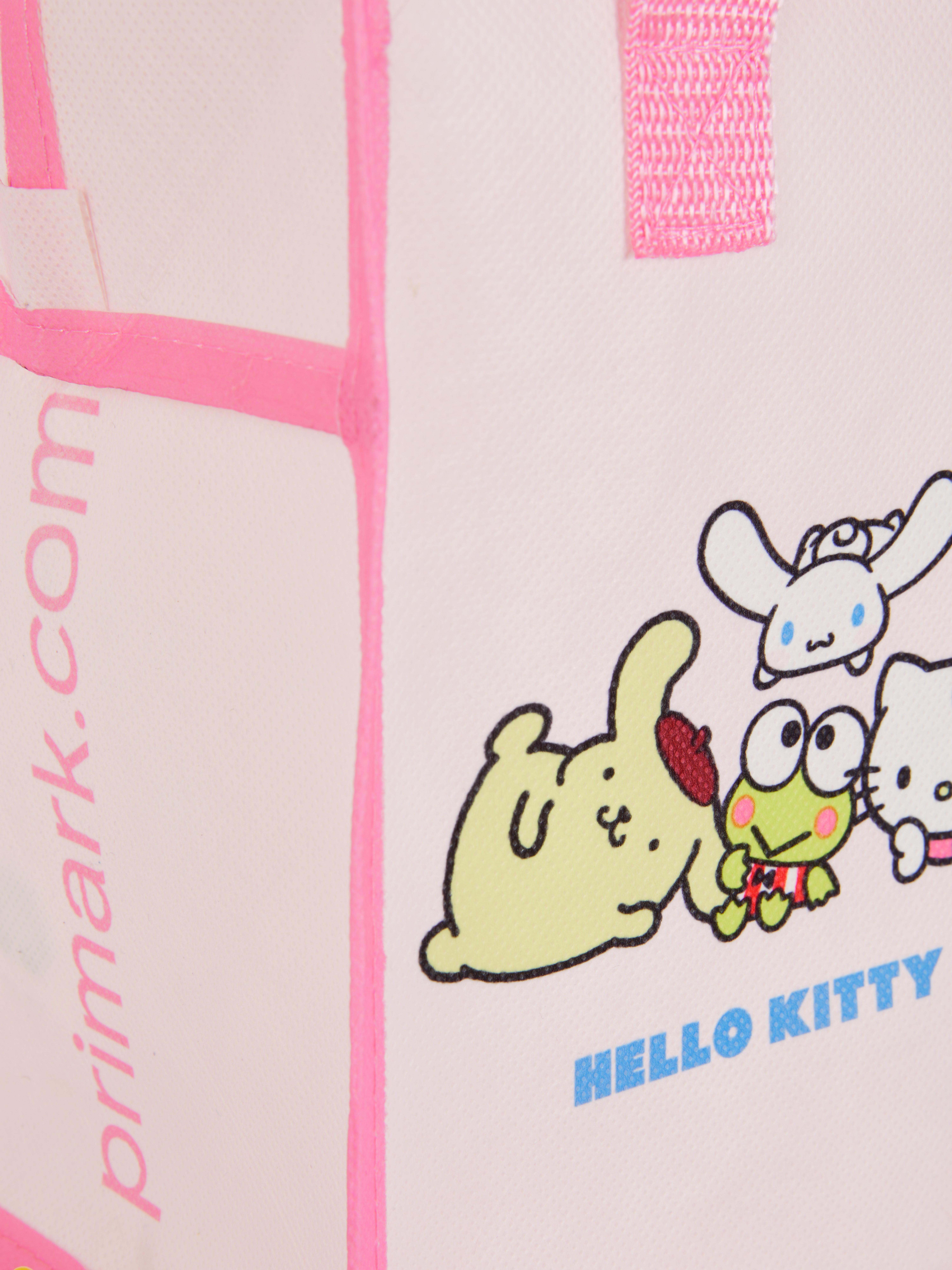 Geantă de prânz Hello Kitty și prietenii O geantă de prânz Hello Kitty cu curea de umăr și imprimeuri