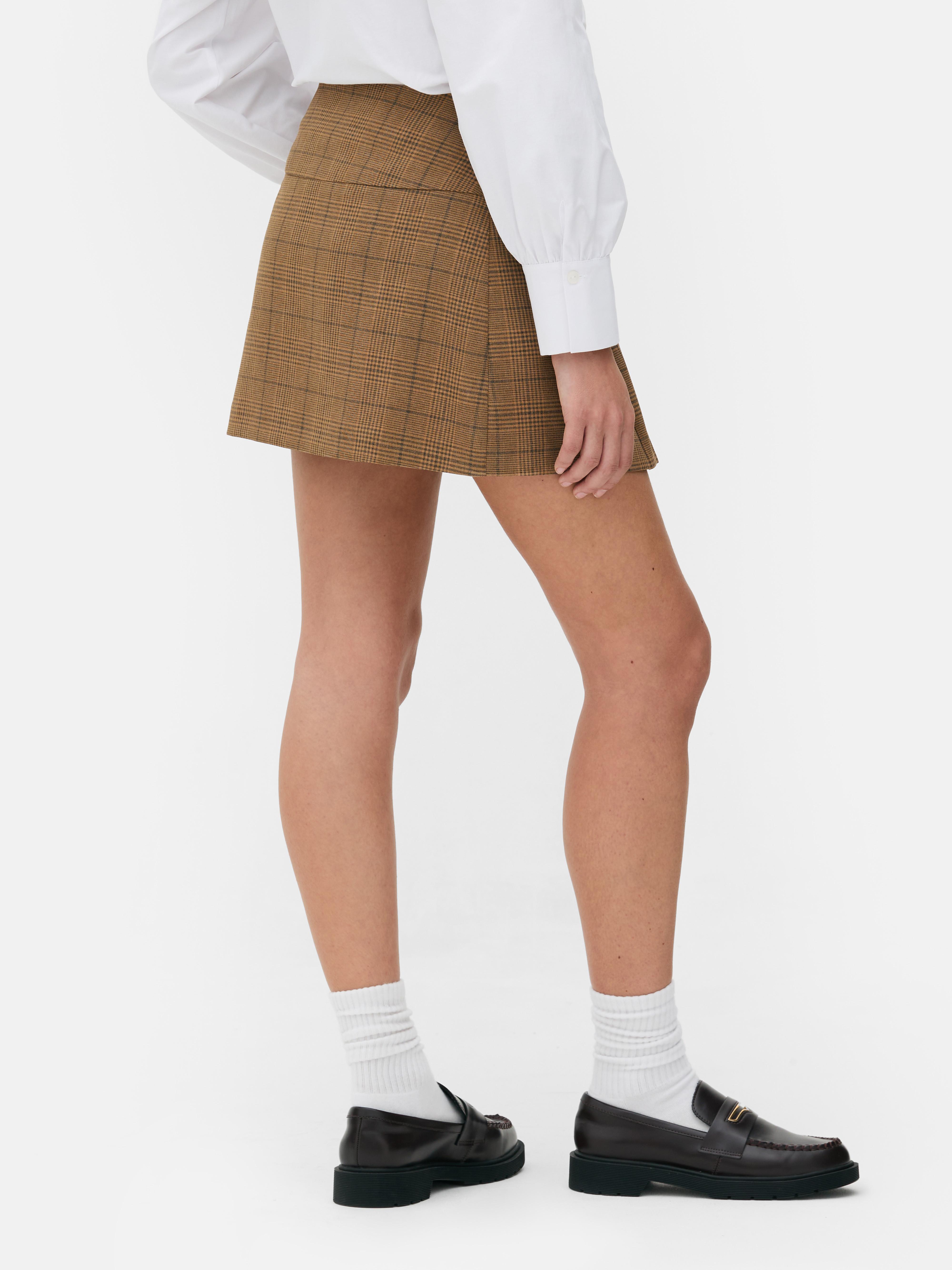 Pleated mini skirt A pleated mini skirt with metallic bit details