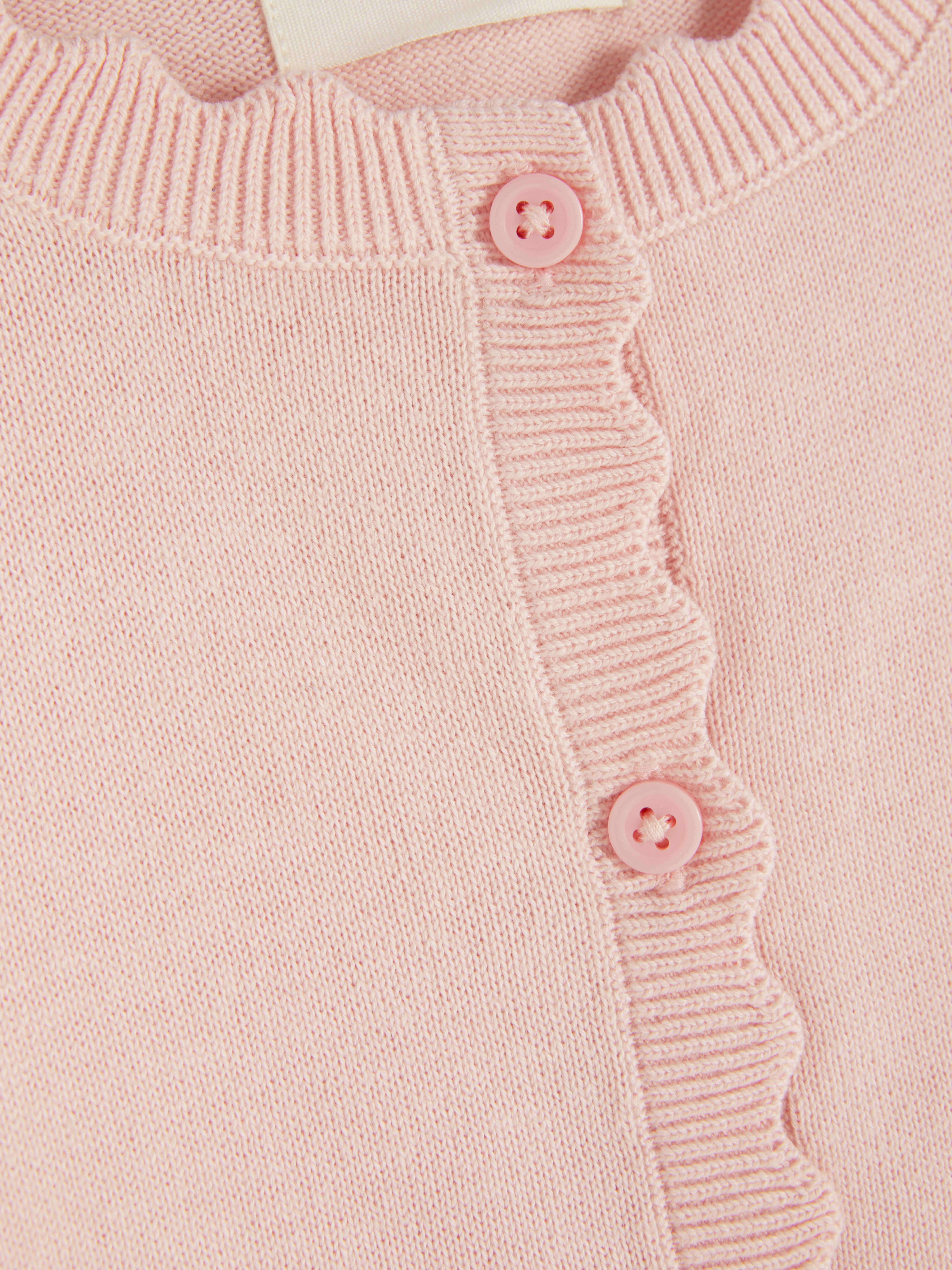 Cardigan with button closure and scalloped edge A cute cardigan with long sleeves, button closure, and scalloped edges