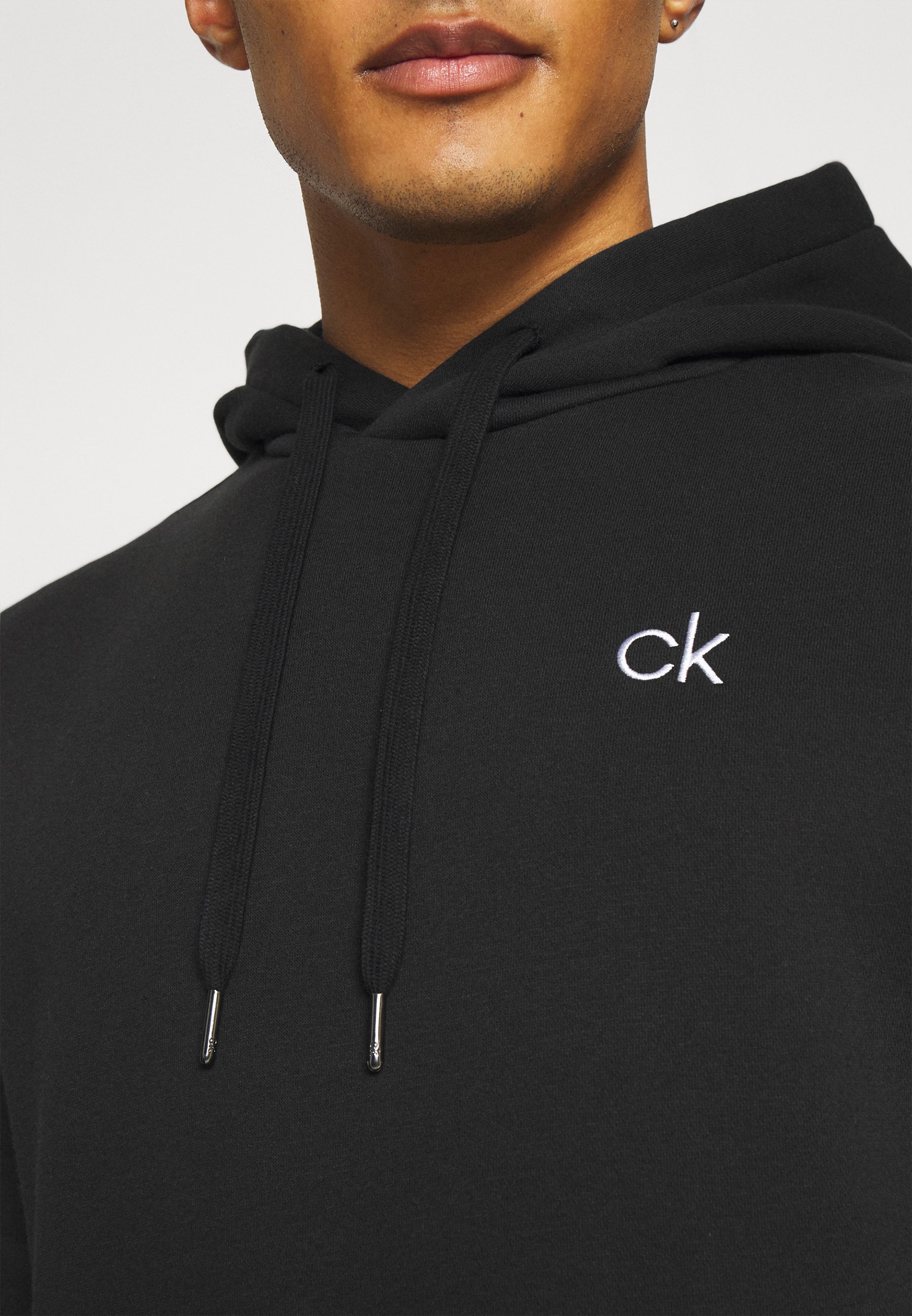 Sweat à capuche Calvin Klein Golf PLANET - Noir