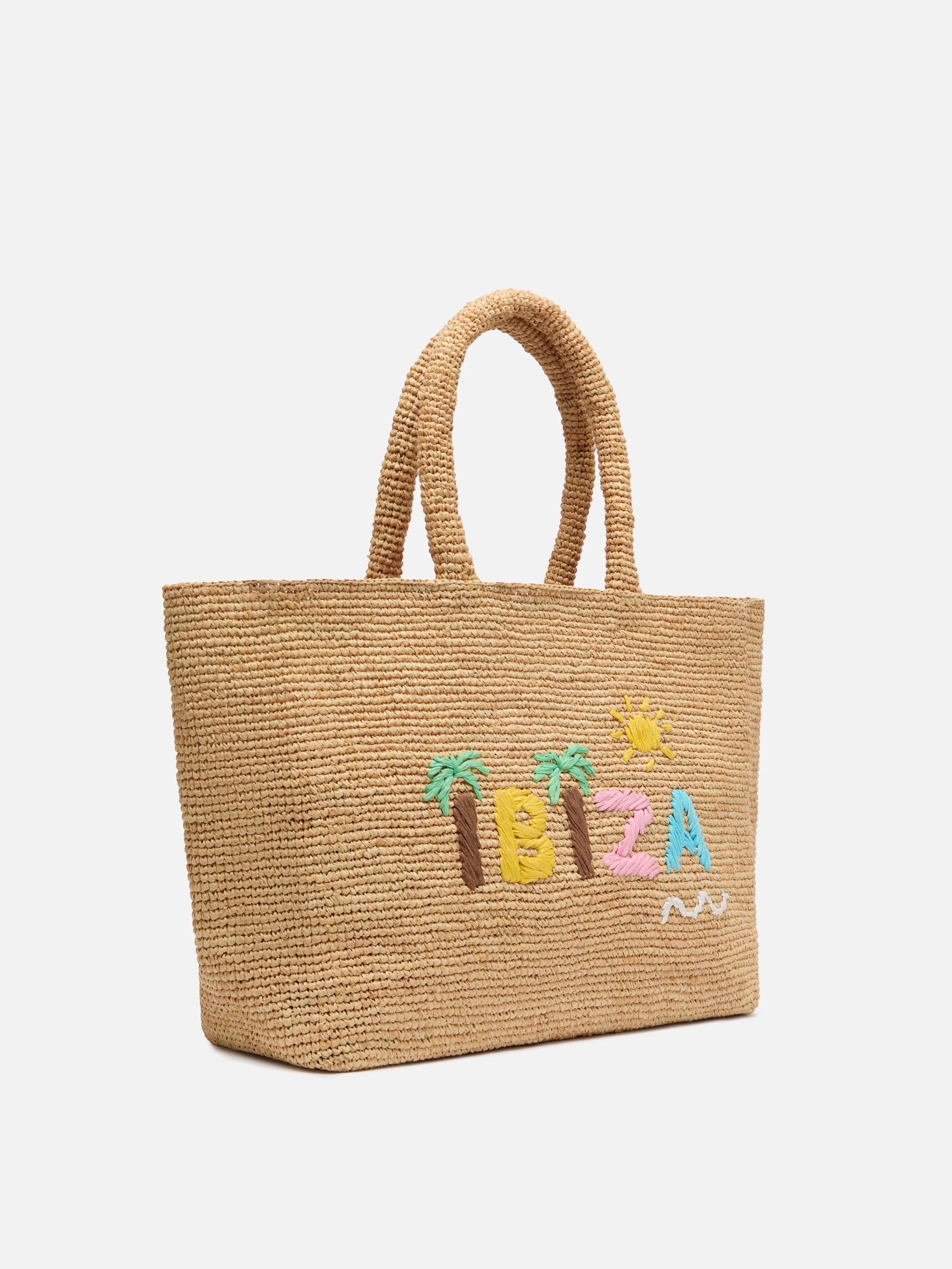 Beige raffia strandtas met katoenen binnenvak en Ibiza-borduurwerk.