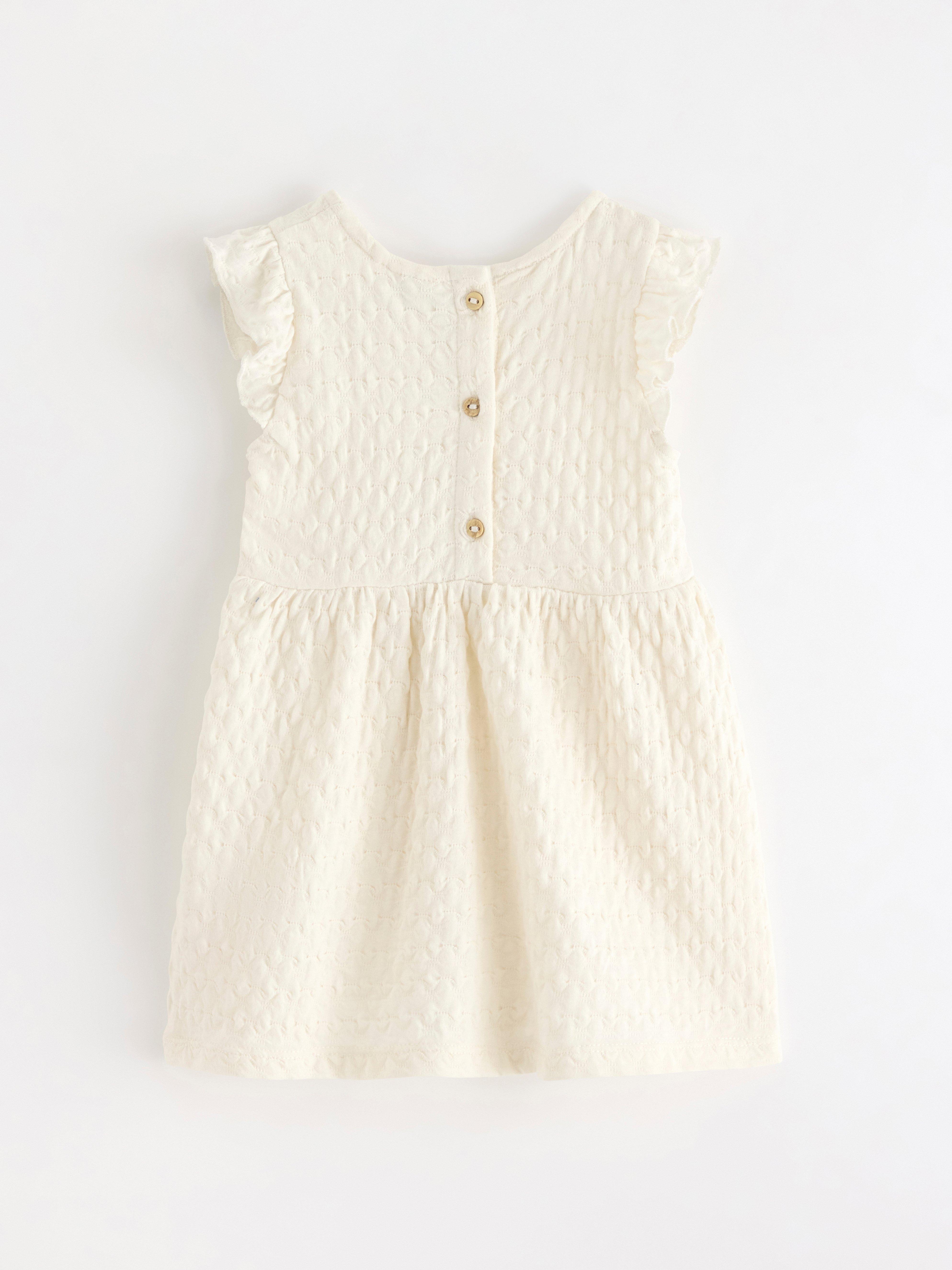 Vestido com babados em tom branco claro acinzentado