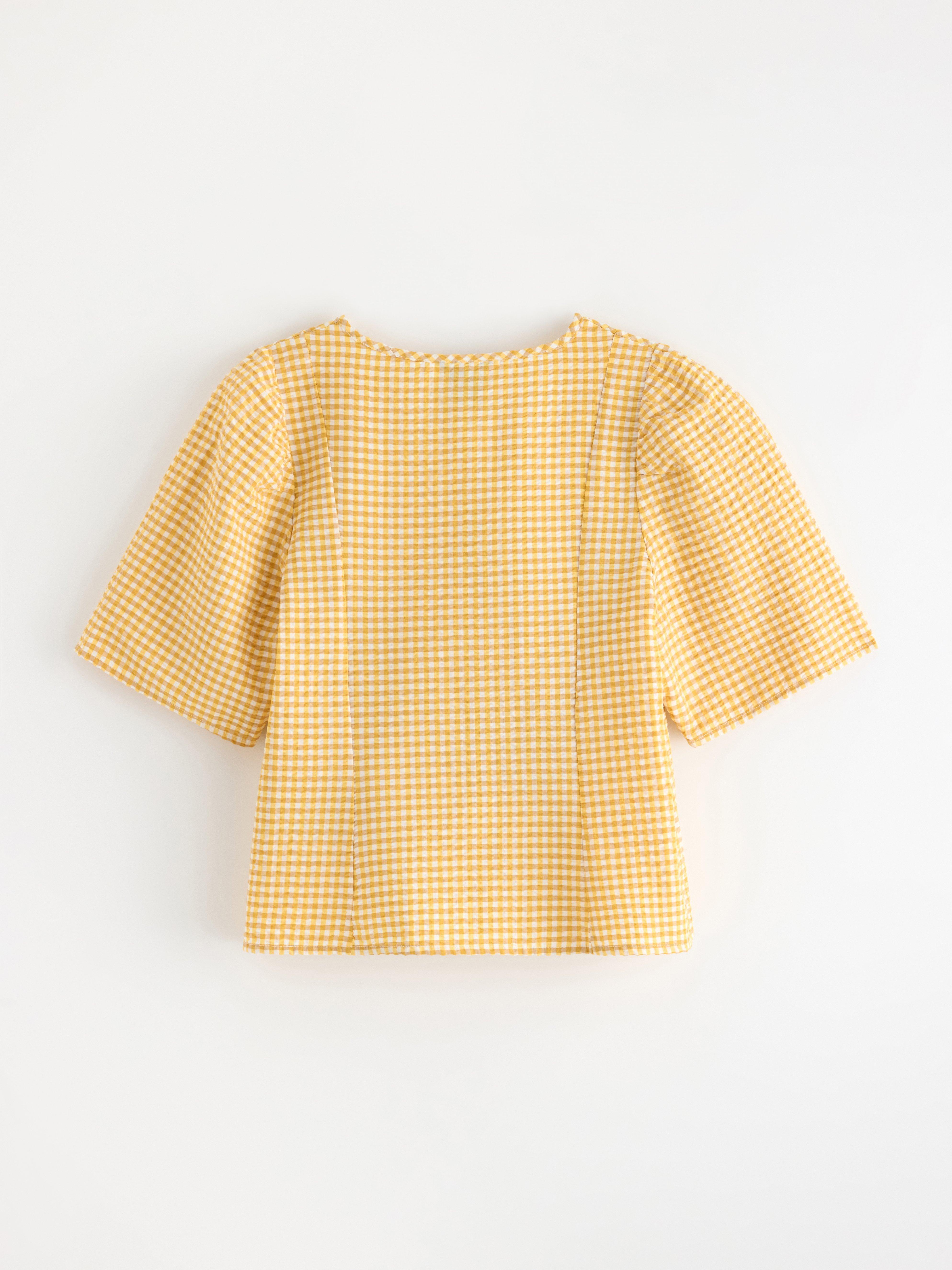 Blusa con estampado de pelícanos amarillos