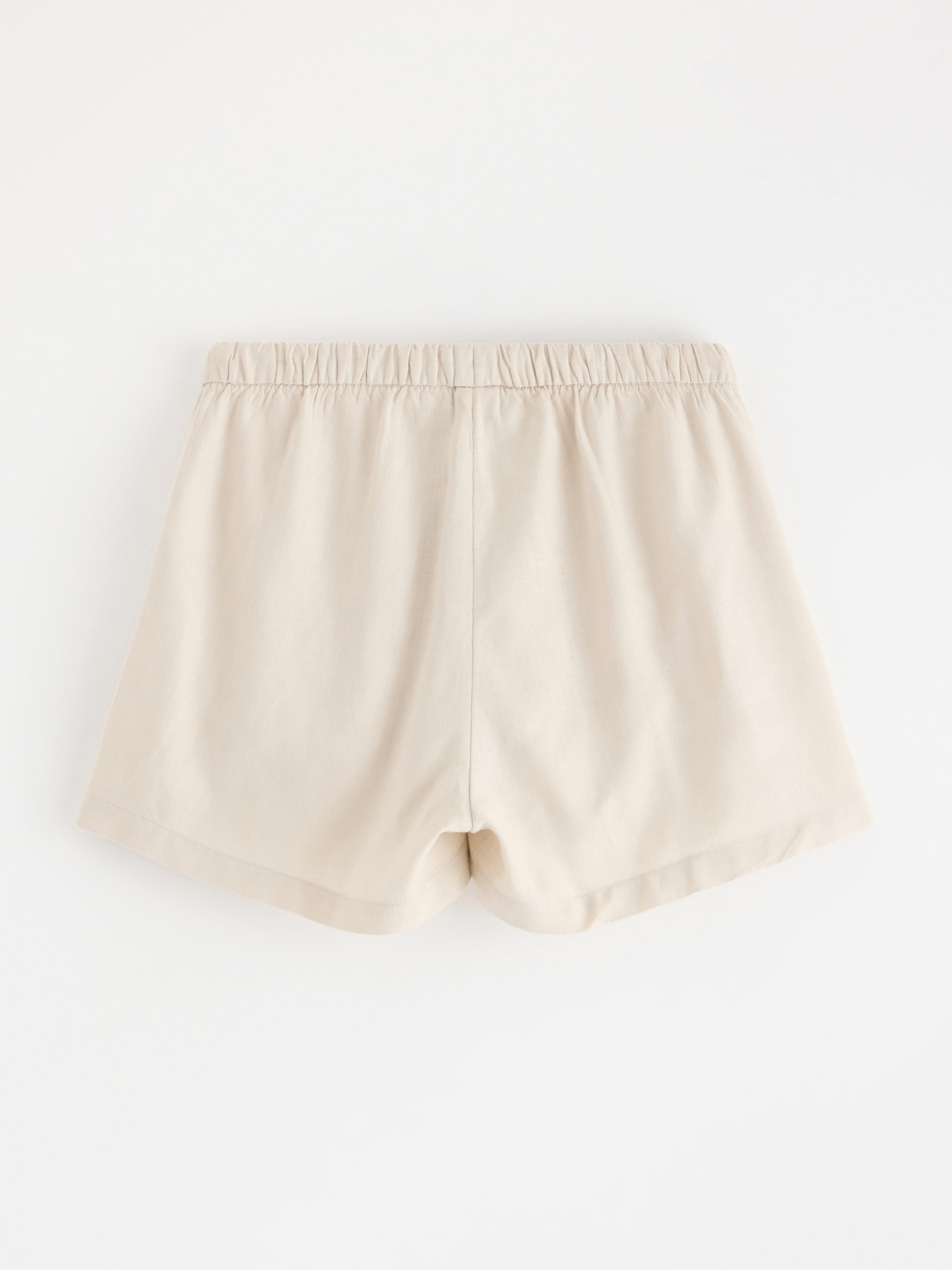 Pantalones cortos de mezcla de lino color beige claro.