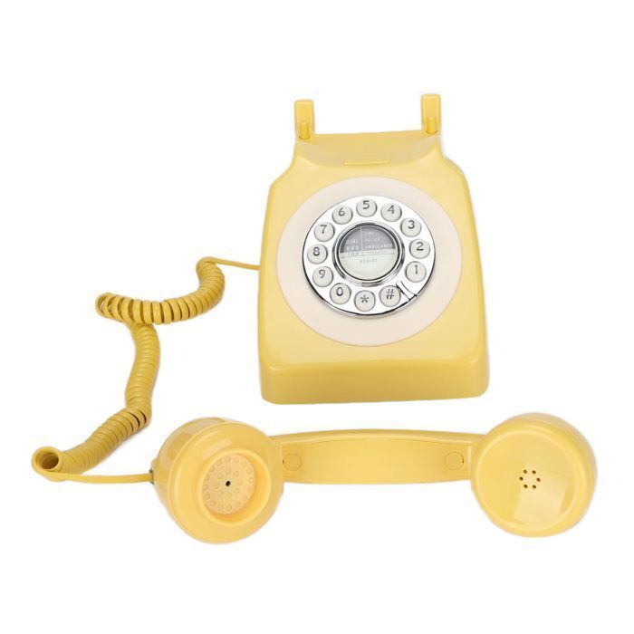 Teléfono fijo clásico retro con cable en color amarillo, estilo vintage, para telefonía doméstica y decoración de interiores.