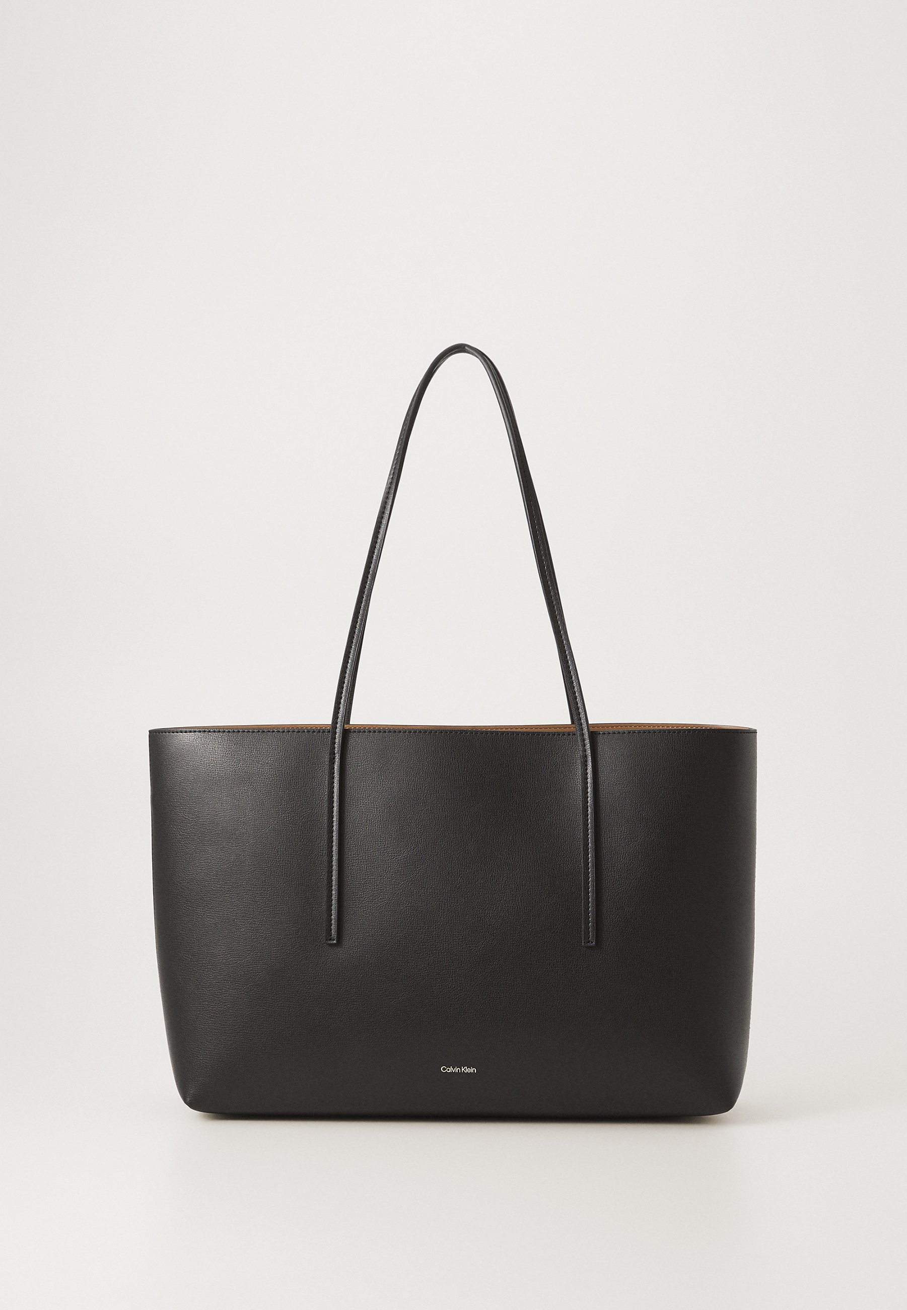 Calvin Klein FOIL LOGO TOTE POUCH - Tote bag - black/toasted coconut