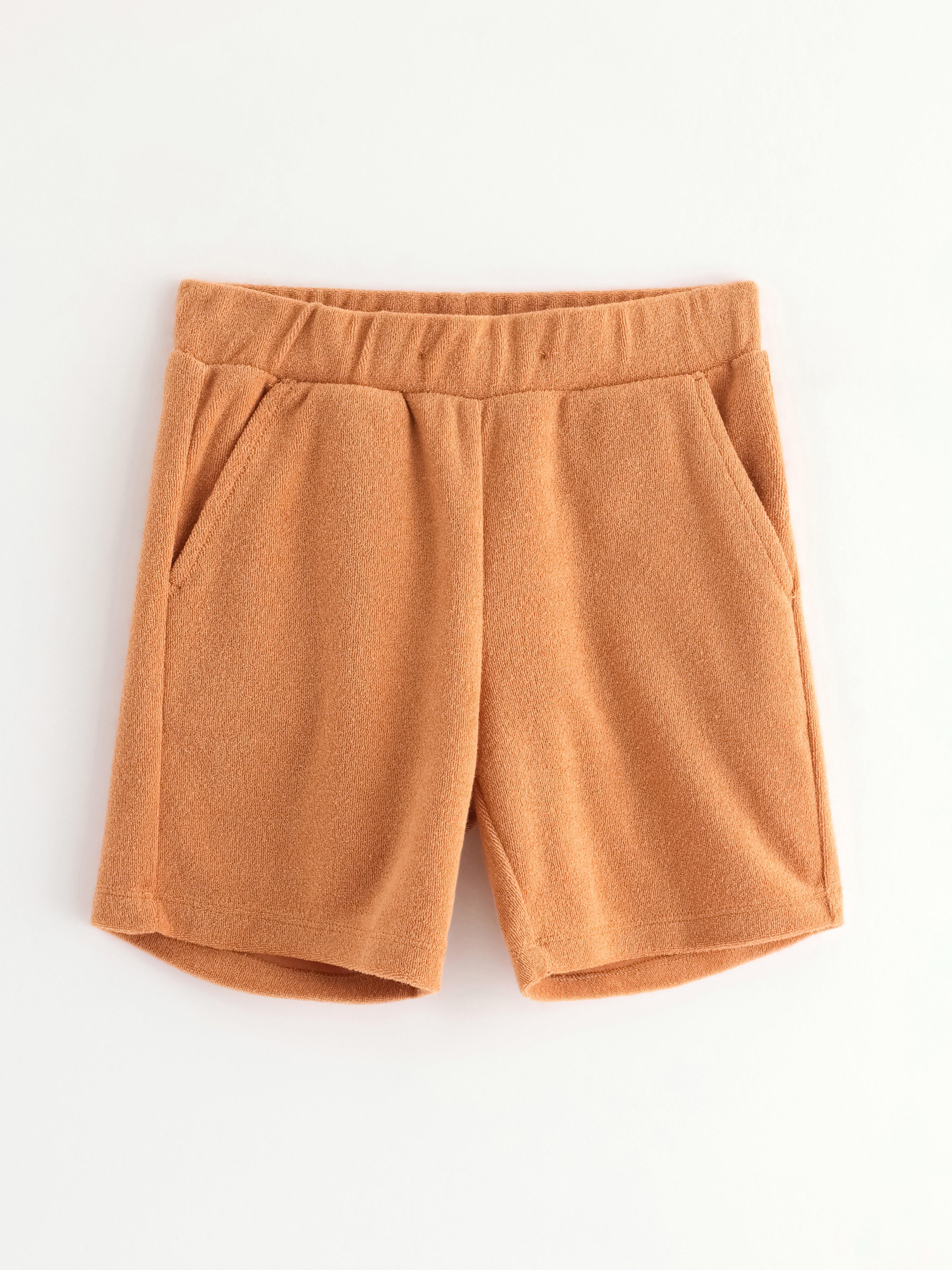 Pantalones cortos de color beige oscuro desgastado