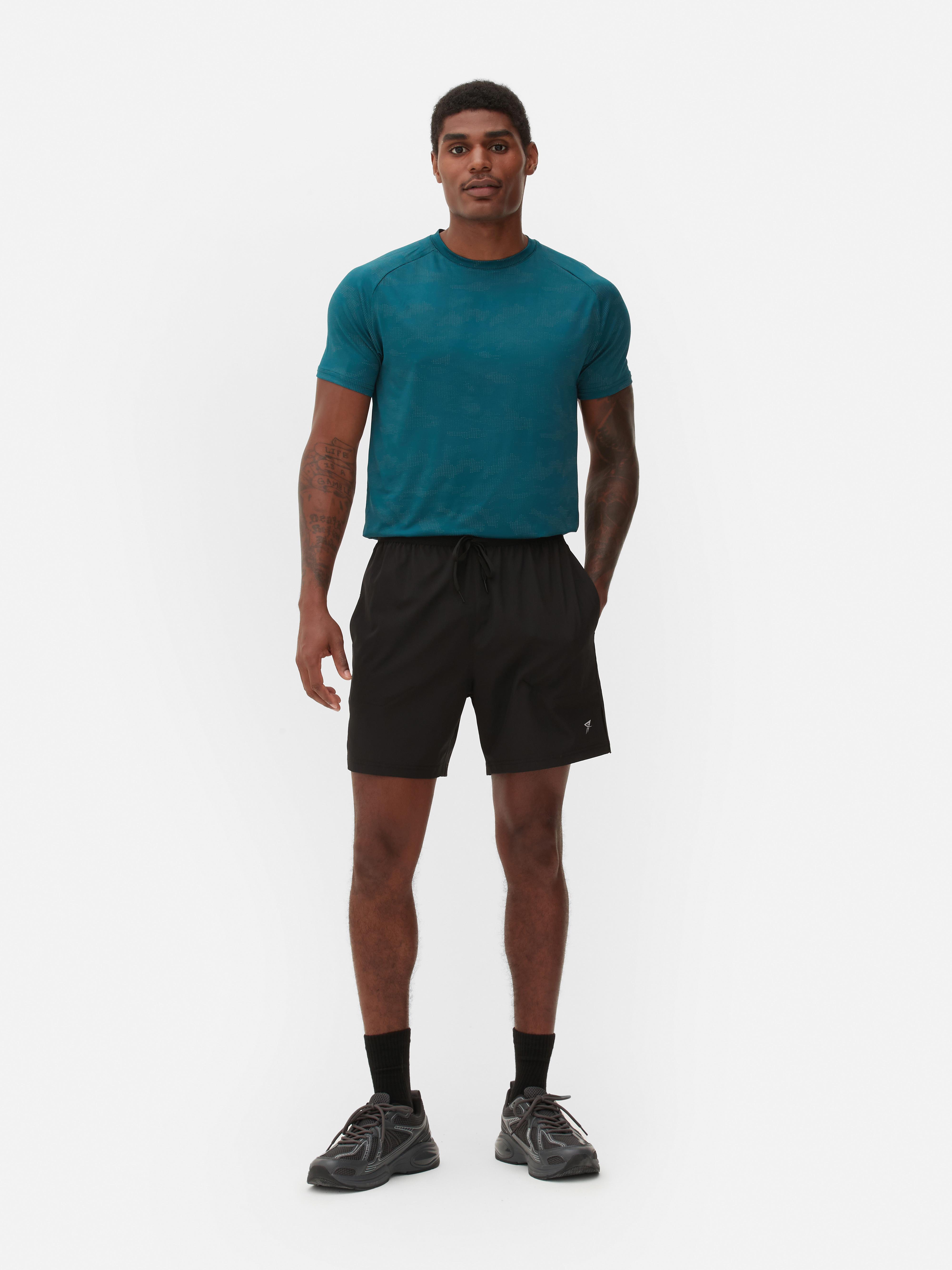 Pantaloni scurți de alergare cu talie elastică Pantaloni scurți sport de alergare cu talie elastică și buzunare multiple