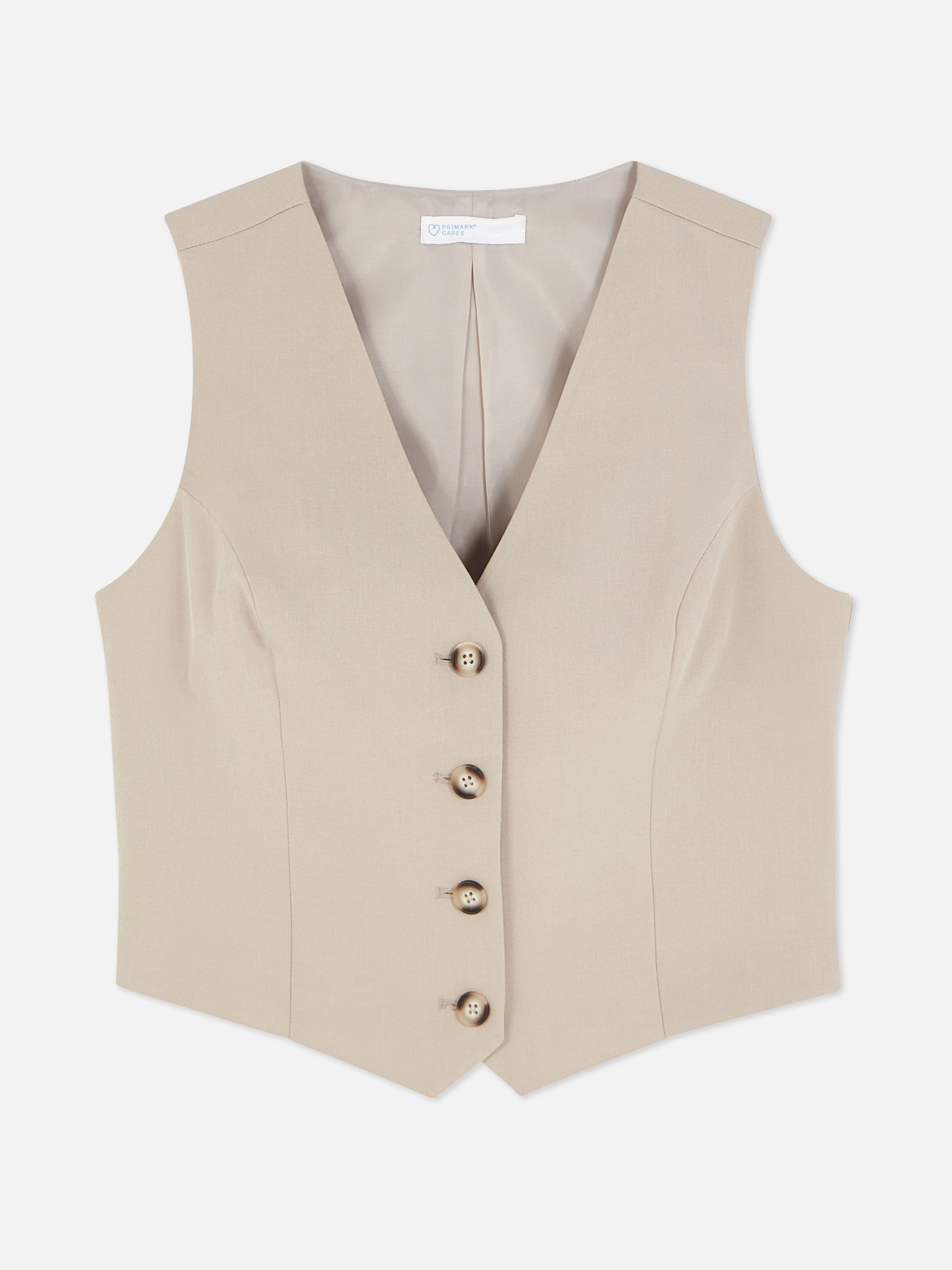 Vestă elegantă cu închidere cu nasturi. Această vestă atemporală, cu cusături prințesă, închidere cu nasturi și decolteu în V, este un adevărat must-have.