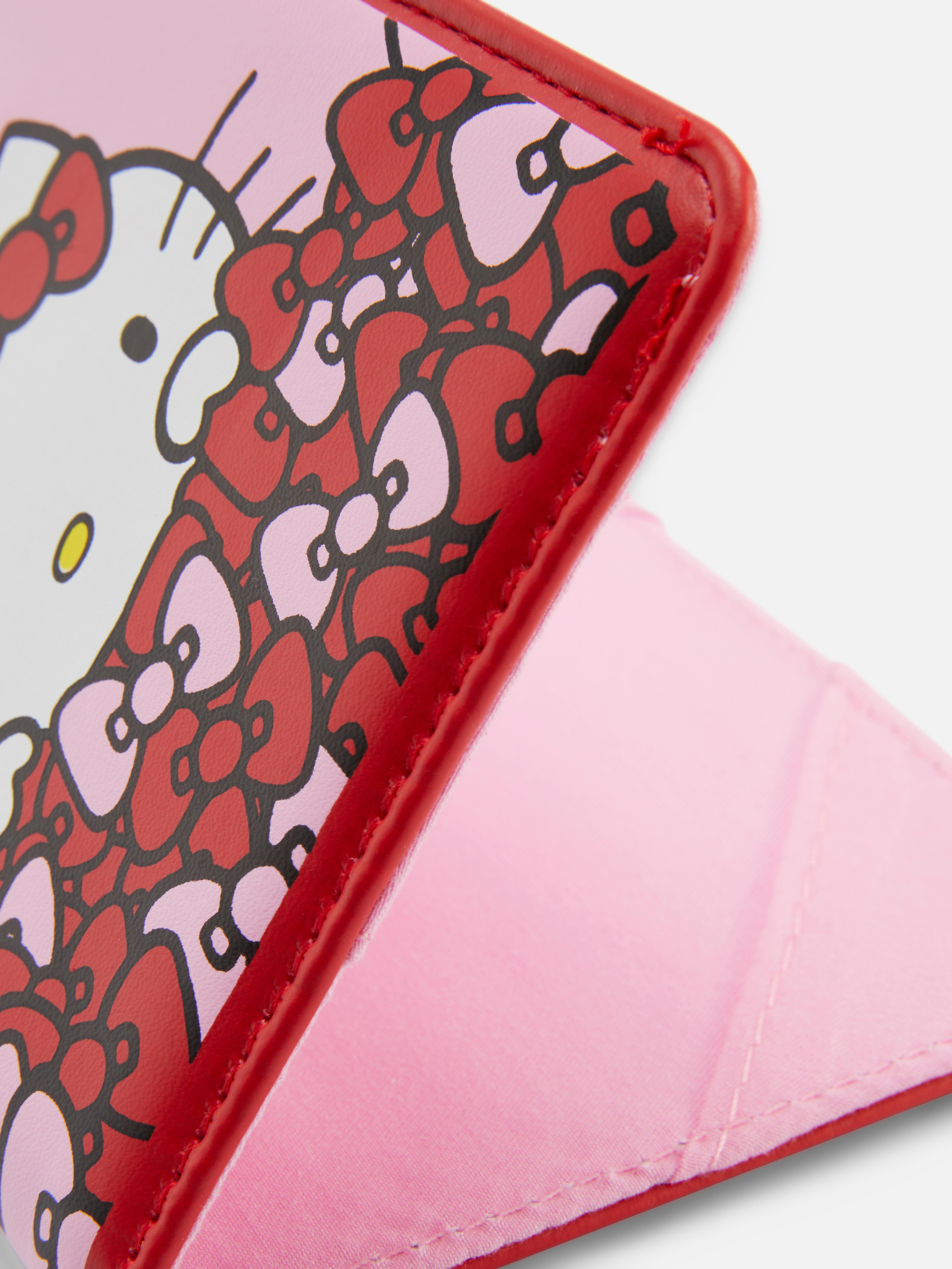 Hello Kitty 50. évfordulós útlevélborító. Ez a Hello Kitty útlevéltartó készen áll a repülésre, a forgatásra és az indulásra.