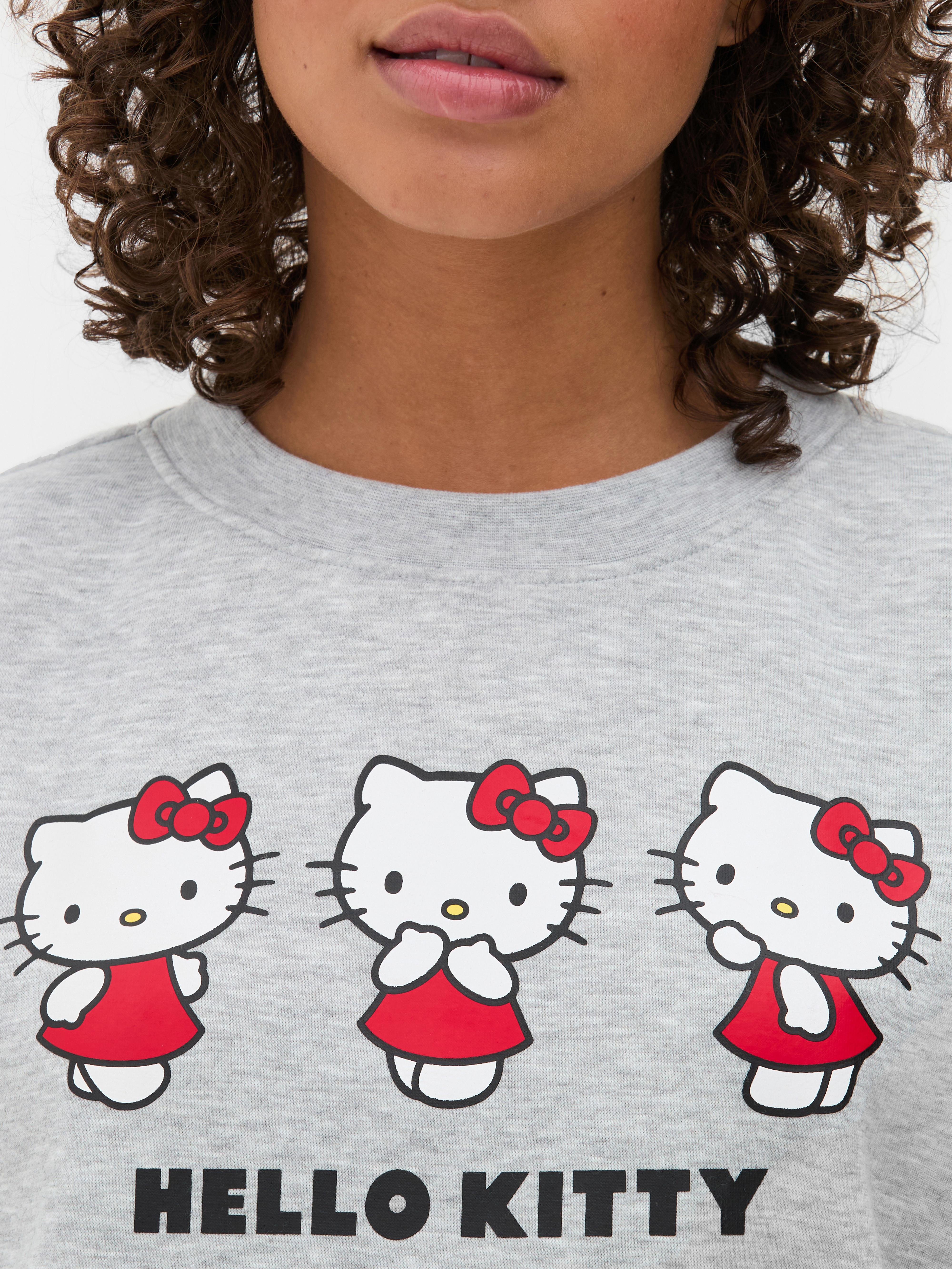Дуксерица са принтом Hello Kitty Дуксерица широког кроја са округлим изрезом, спуштеним раменима и принтом Hello Kitty
