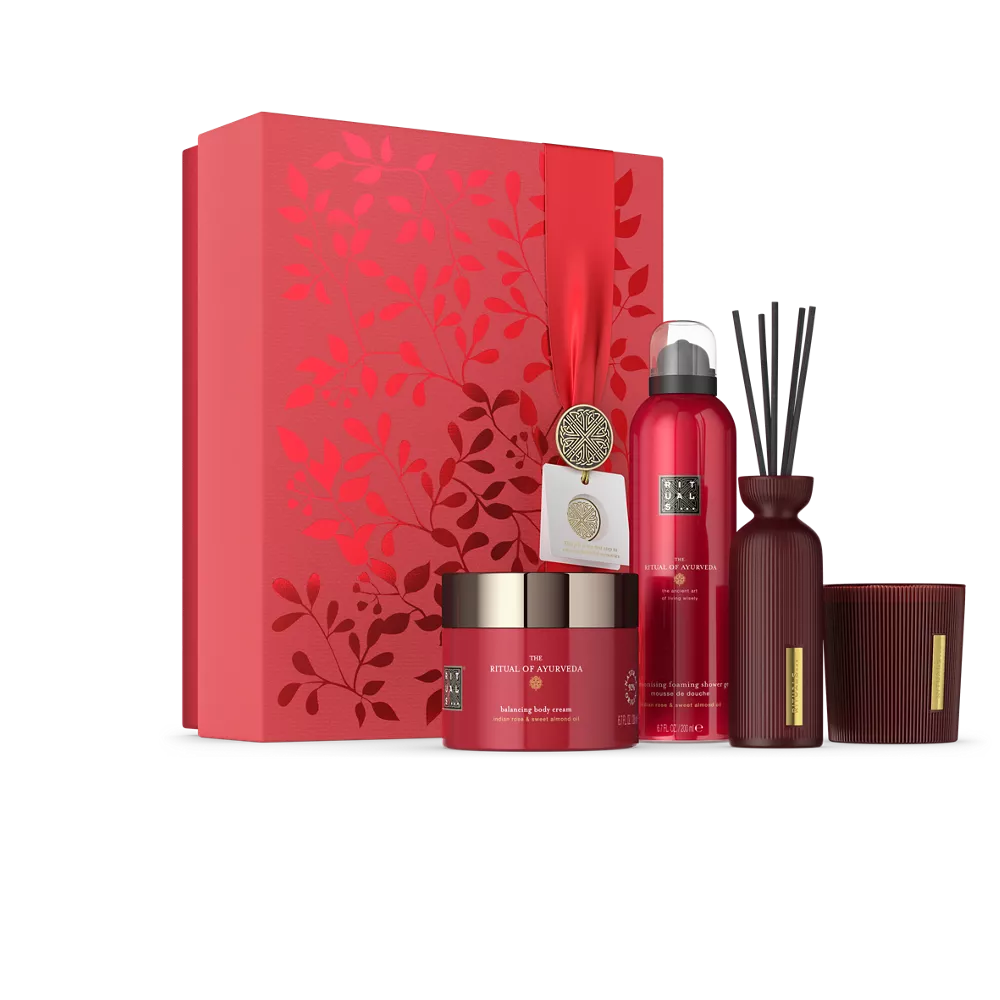 El set de regalo Ritual of Ayurveda L: gel de ducha espumoso 200 ml, crema corporal 200 ml, vela aromática 140 g, mini varitas aromáticas 70 ml.