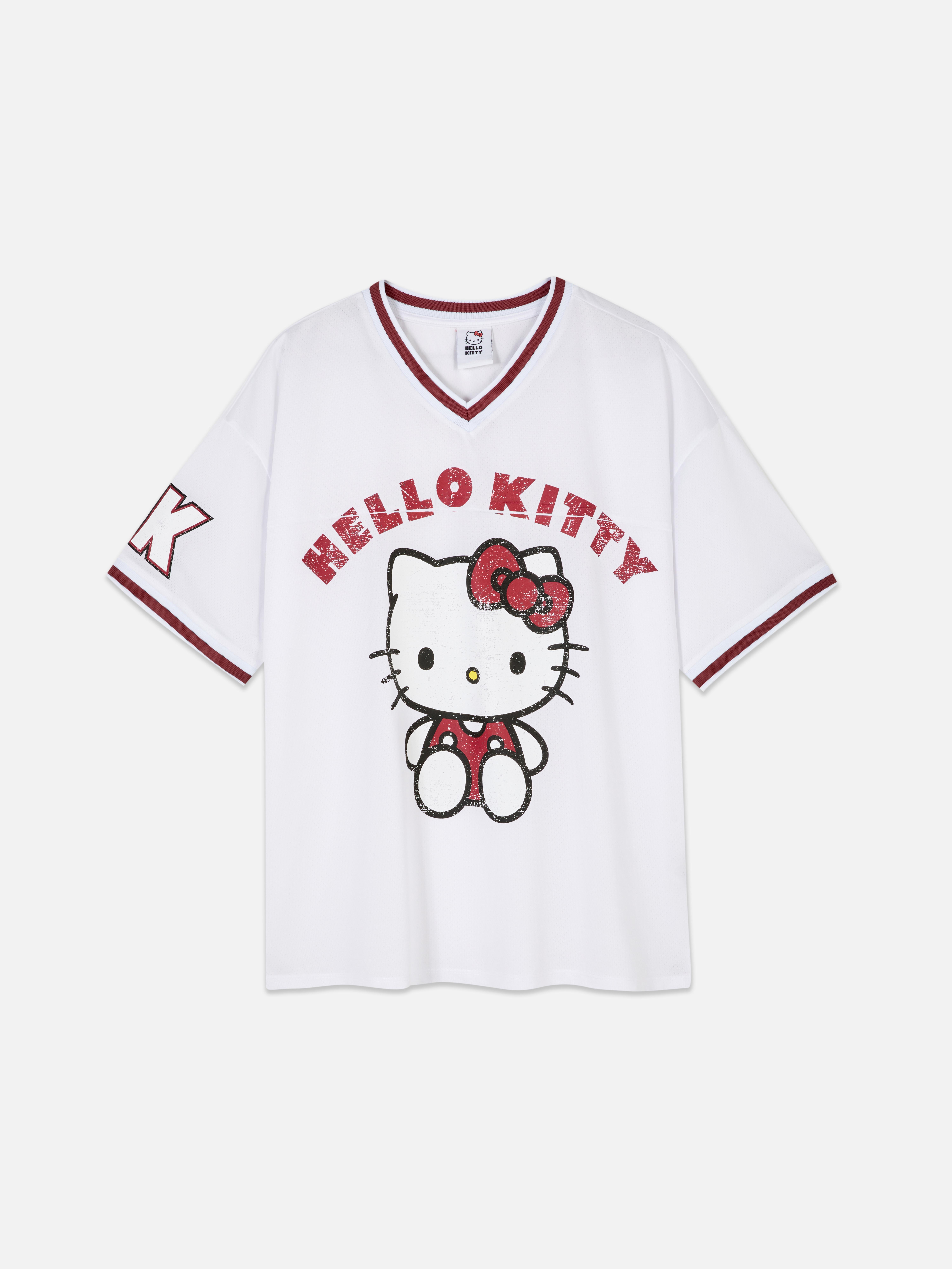 Hello Kitty Fußballtrikot Ein Fußballtrikot mit V-Ausschnitt, kurzen Ärmeln und Hello Kitty-Aufdruck