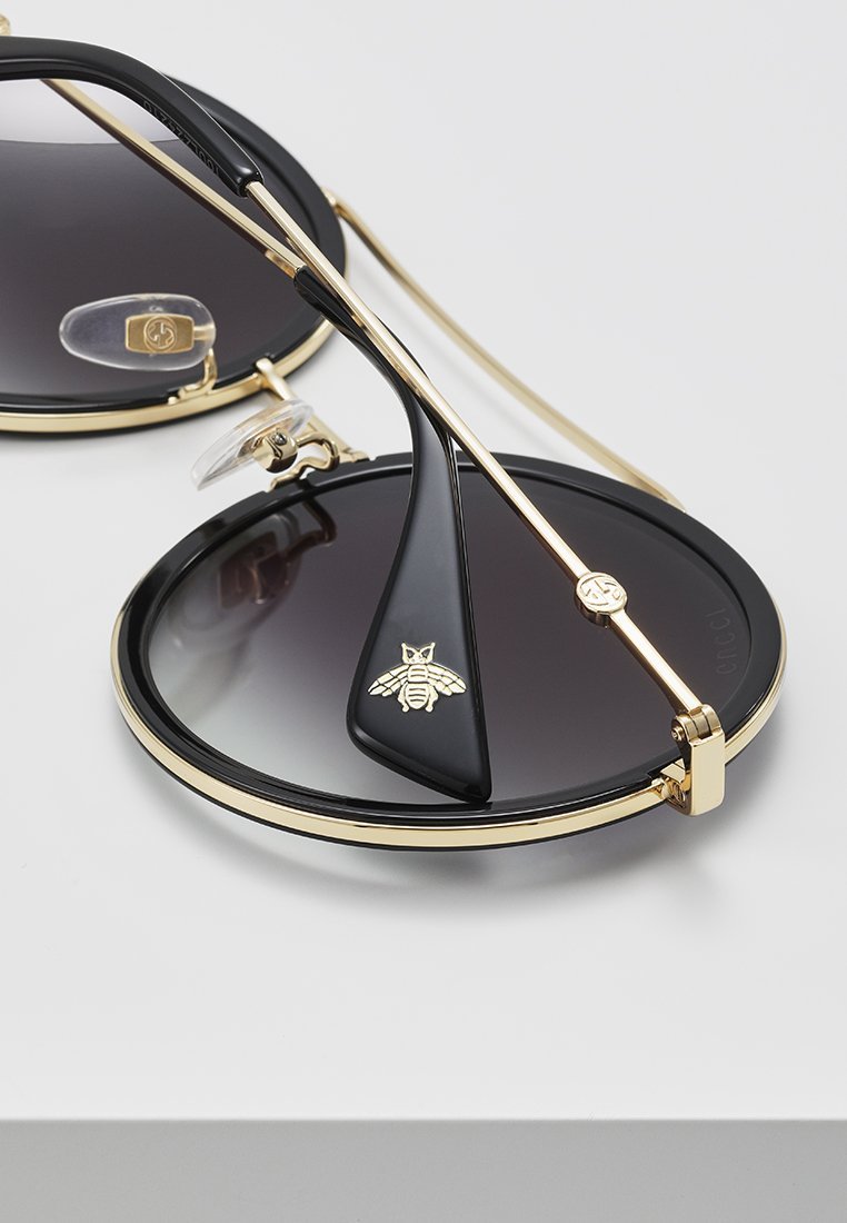 Lunettes de soleil Gucci - dorées/grises