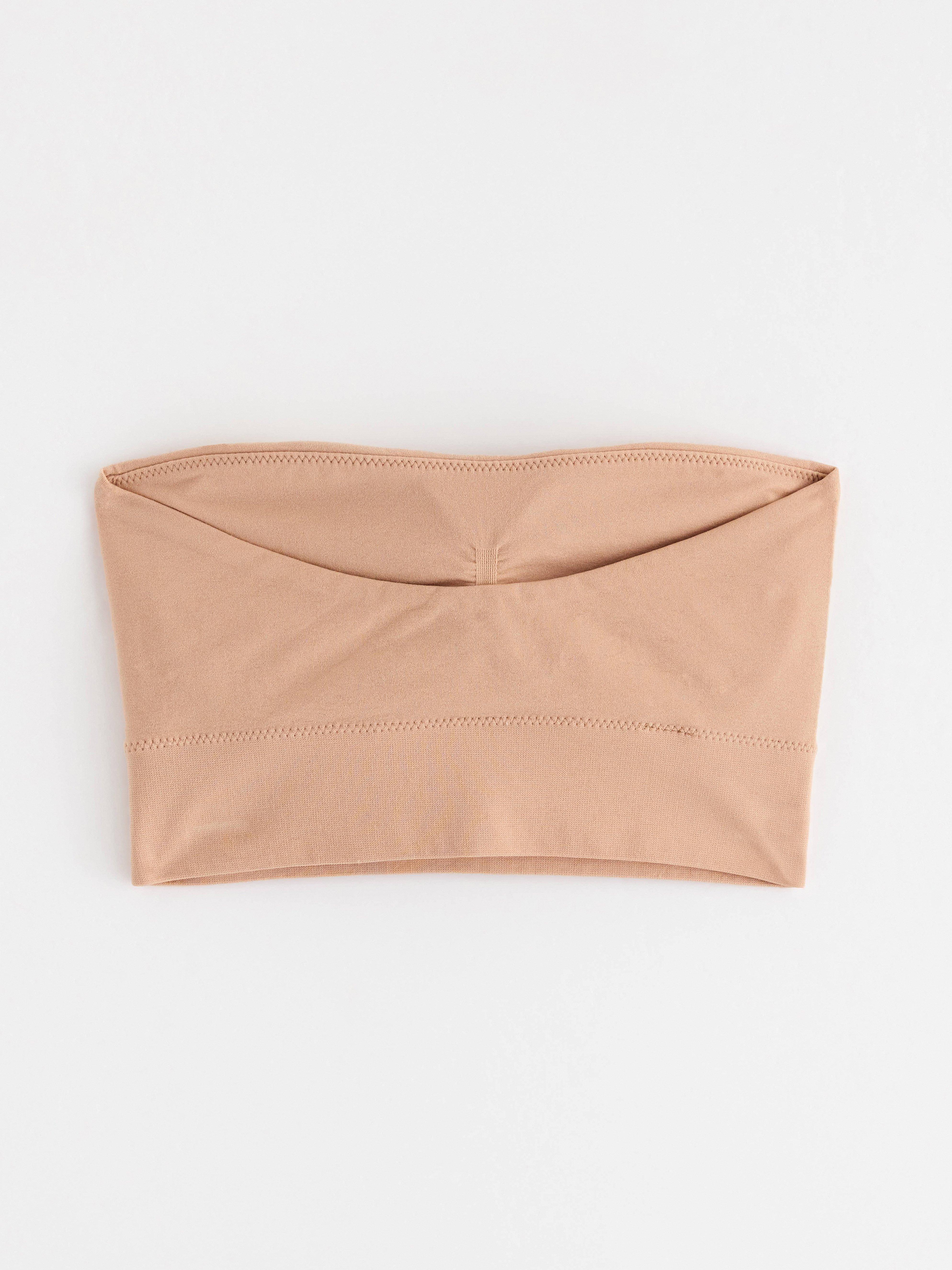 Sujetador bandeau sin costuras, color beige.