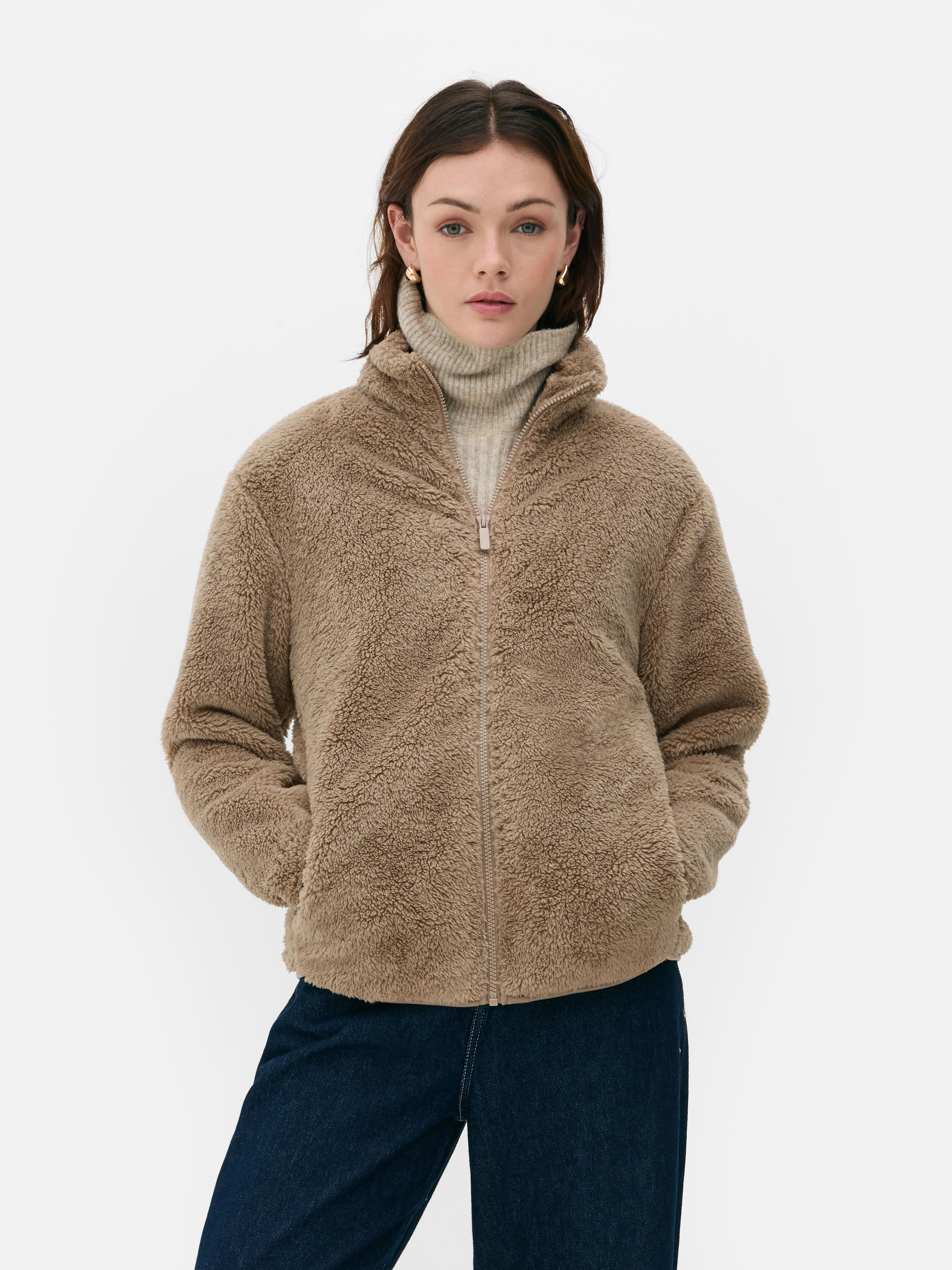 Teddy fleece zippered jacket. A soft teddy fleece jacket with long sleeves, a stand-up collar, and a full-length zipper.