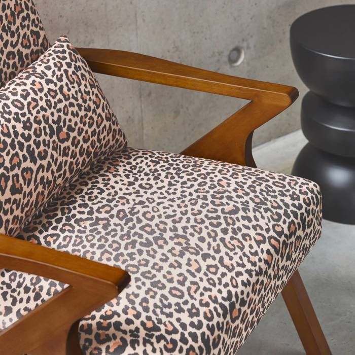 Sillón escandinavo ANTOINE en madera de caucho y estampado de leopardo.