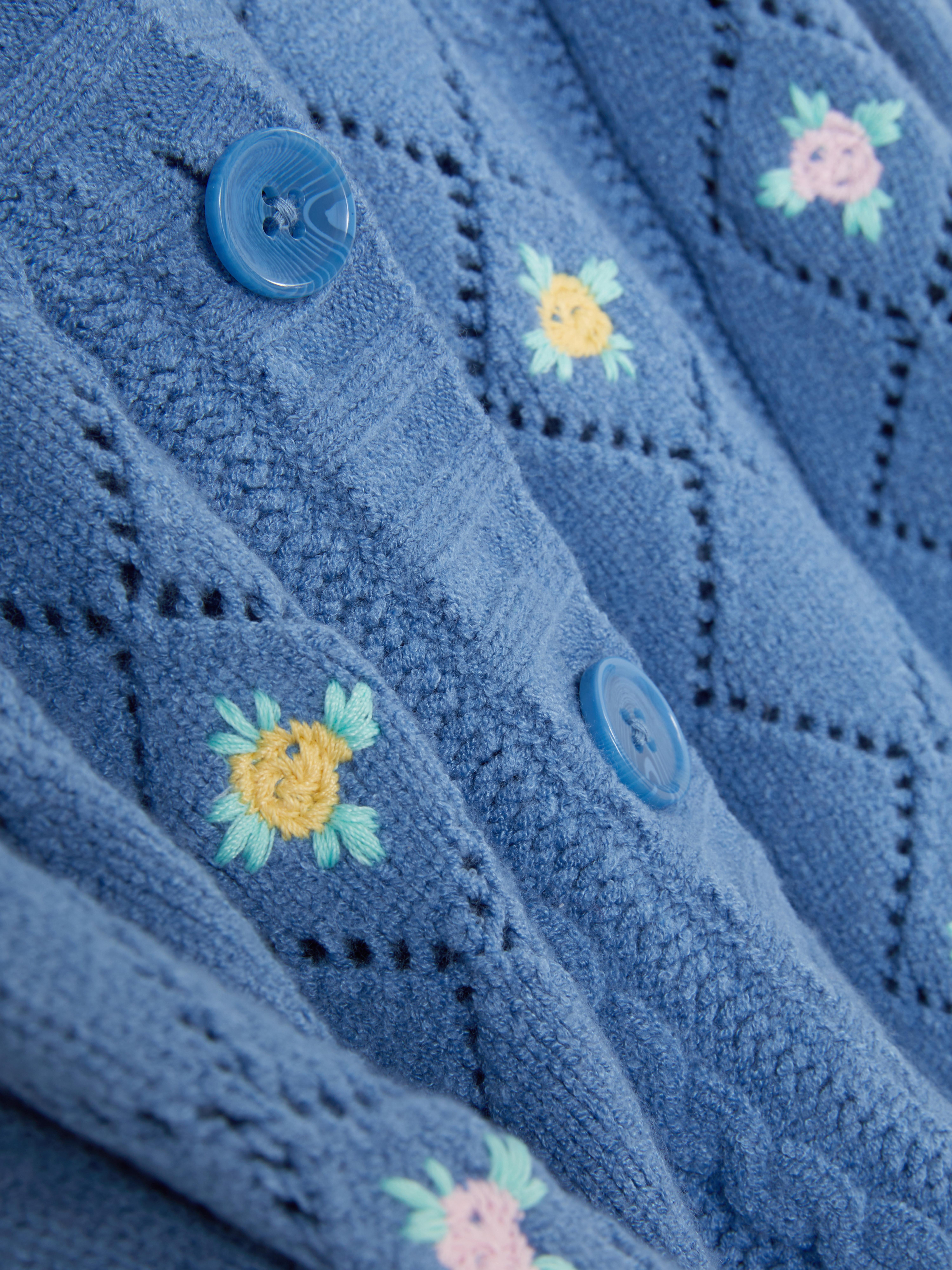 Geborduurd vest met V-hals Gebreid vest met V-hals, knoopsluiting en levendige geborduurde details