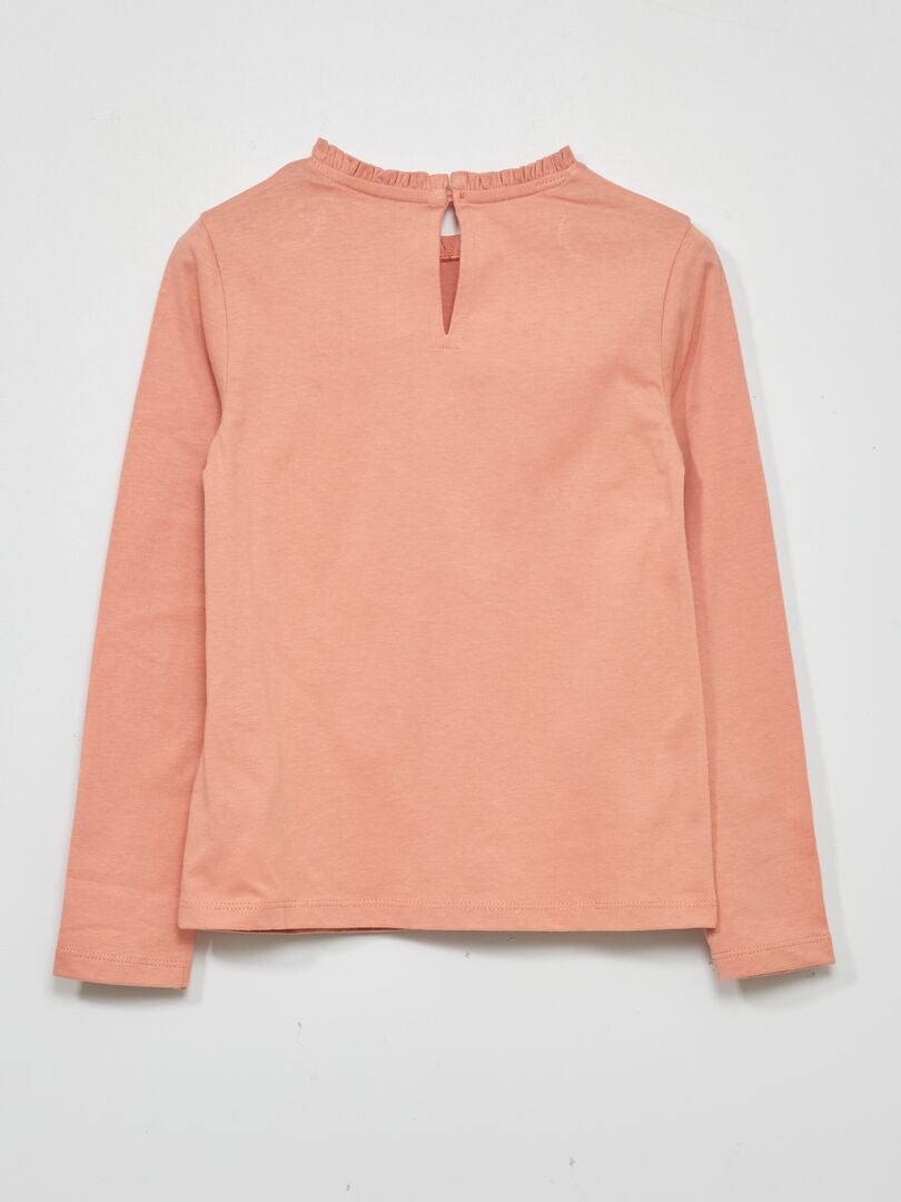 Camiseta rosa con mangas de encaje