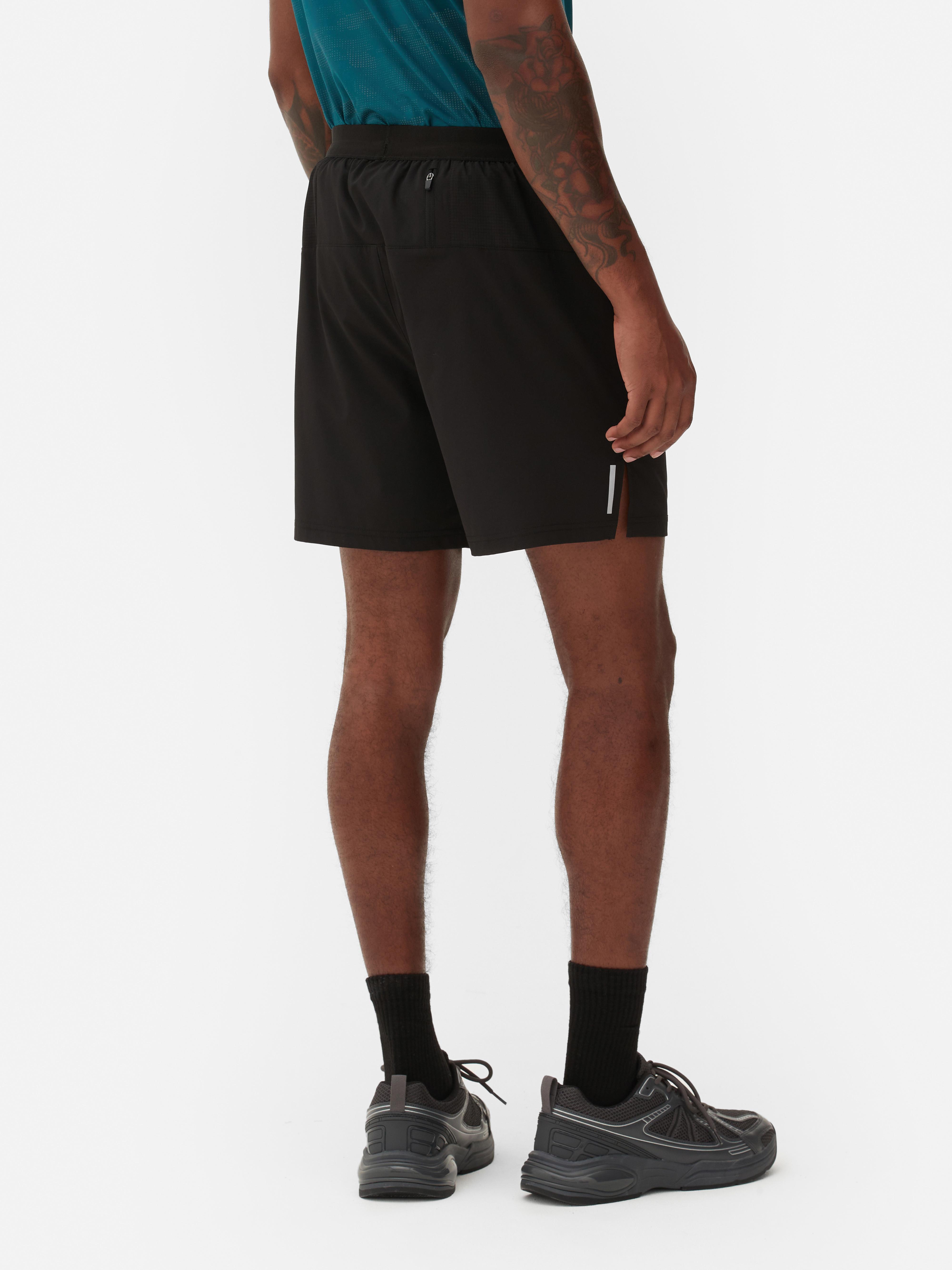 Pantaloni scurți de alergare cu talie elastică Pantaloni scurți sport de alergare cu talie elastică și buzunare multiple