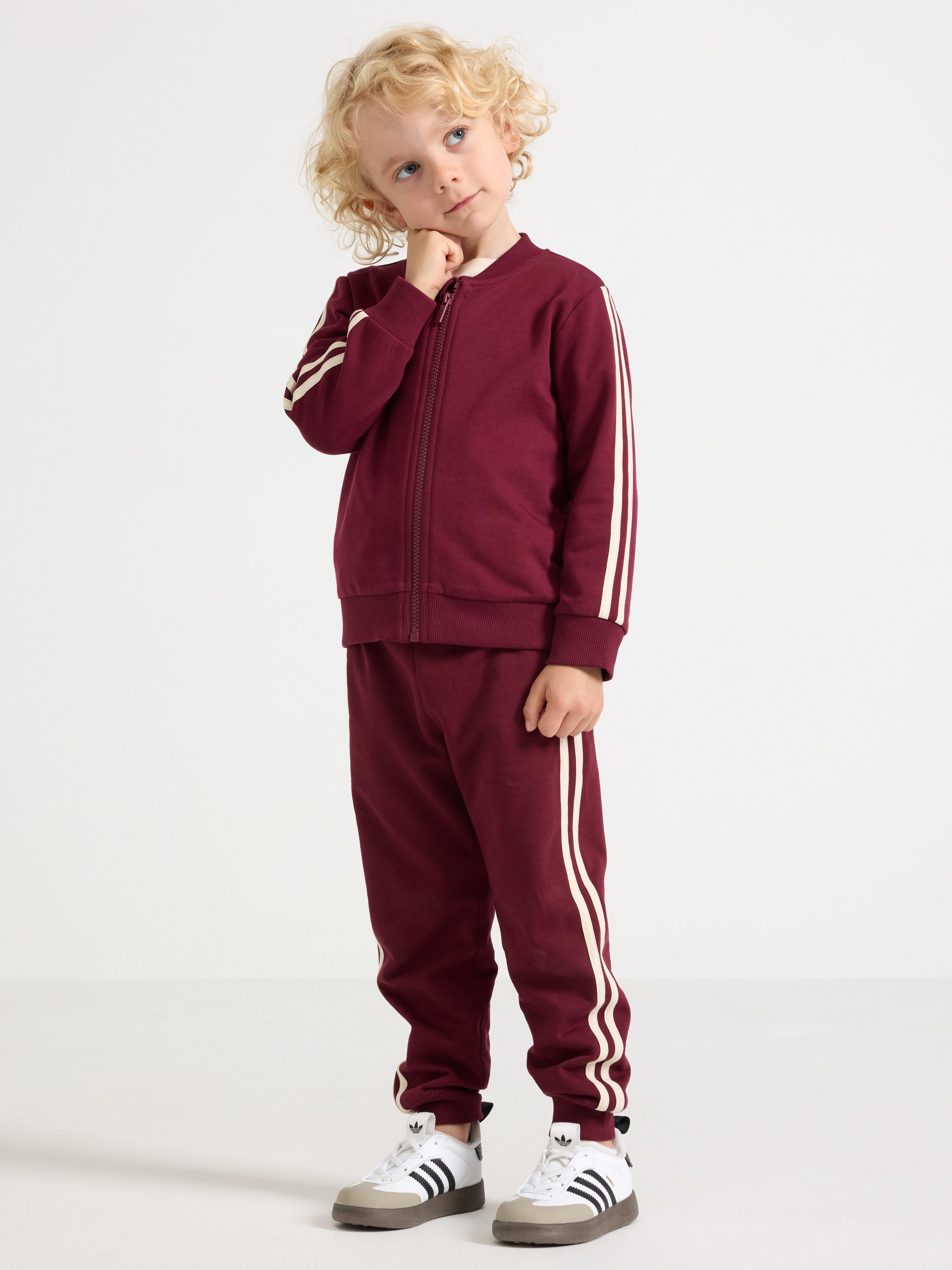 Sudadera con cremallera, color rojo oscuro empolvado.
