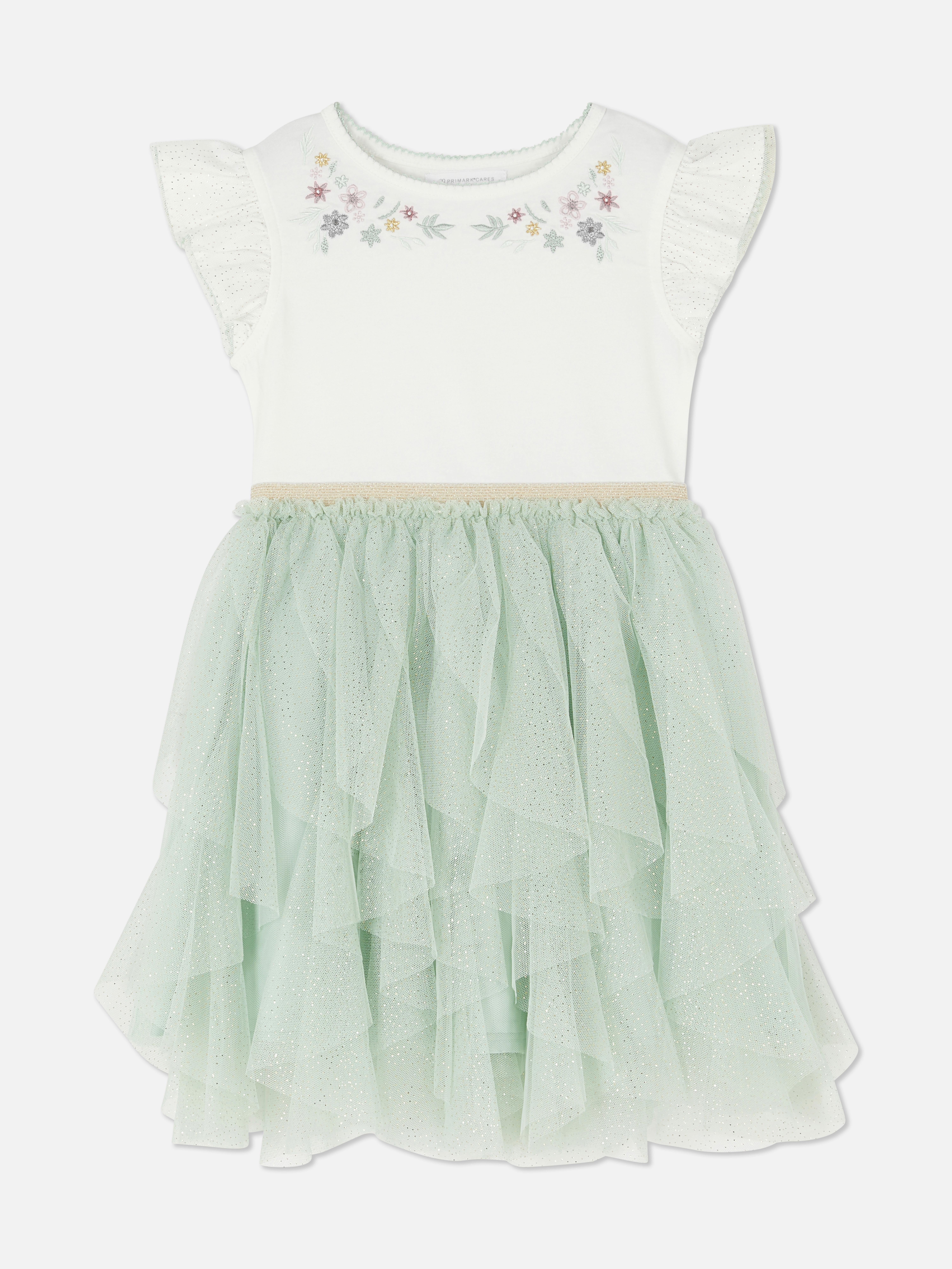 Rochie tutu cu imprimeu floral și volane. Rochie cu fustă din tul cu broderie florală și mâneci scurte cu broderie englezească.
