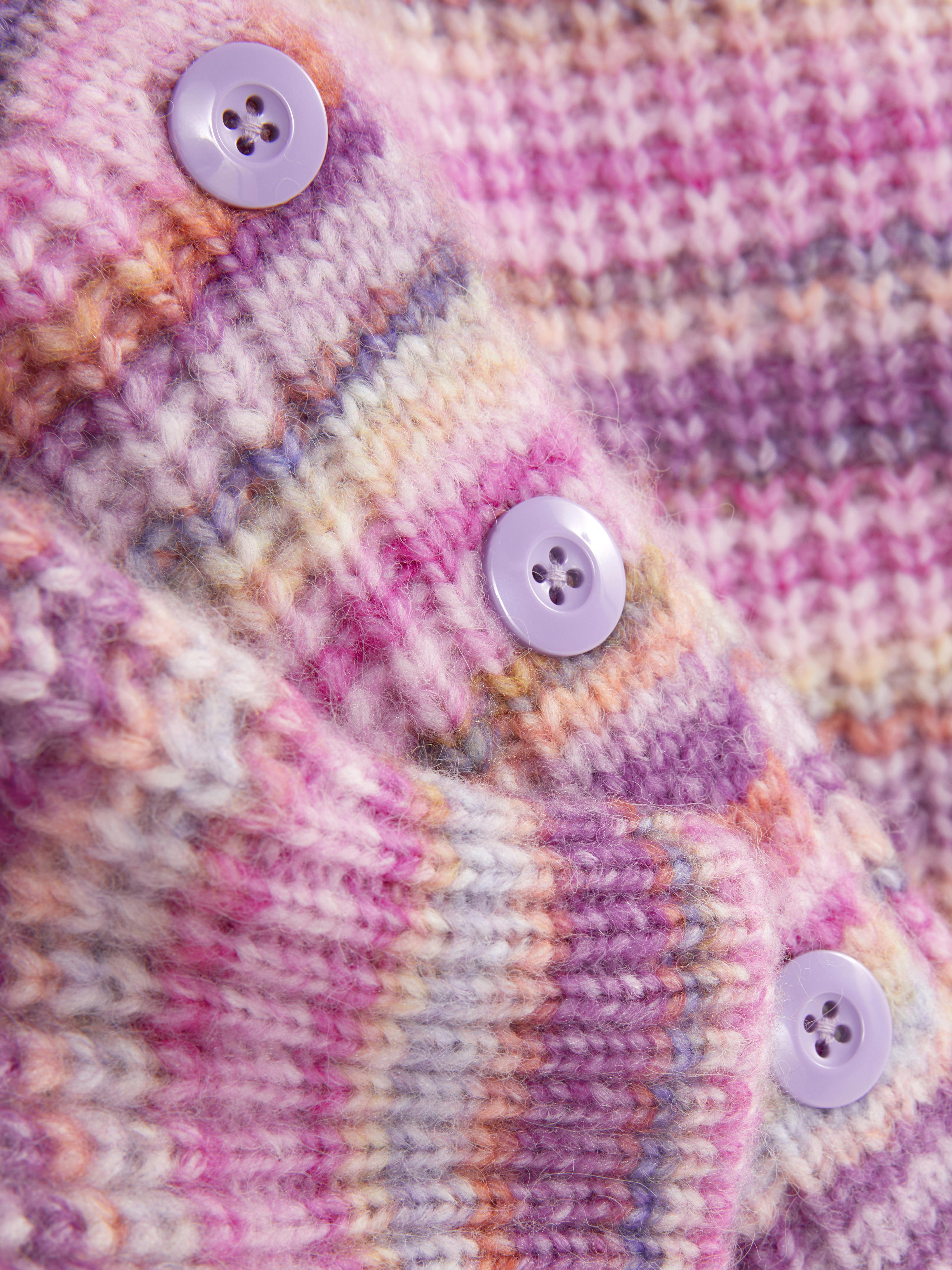 Striped and buttoned cardigan. This cardigan features a V-neck, button fastening at the front, and puff sleeves.